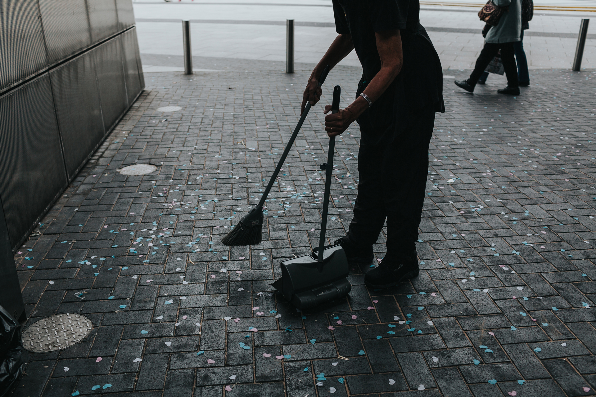 Someone brushes up the confetti. 