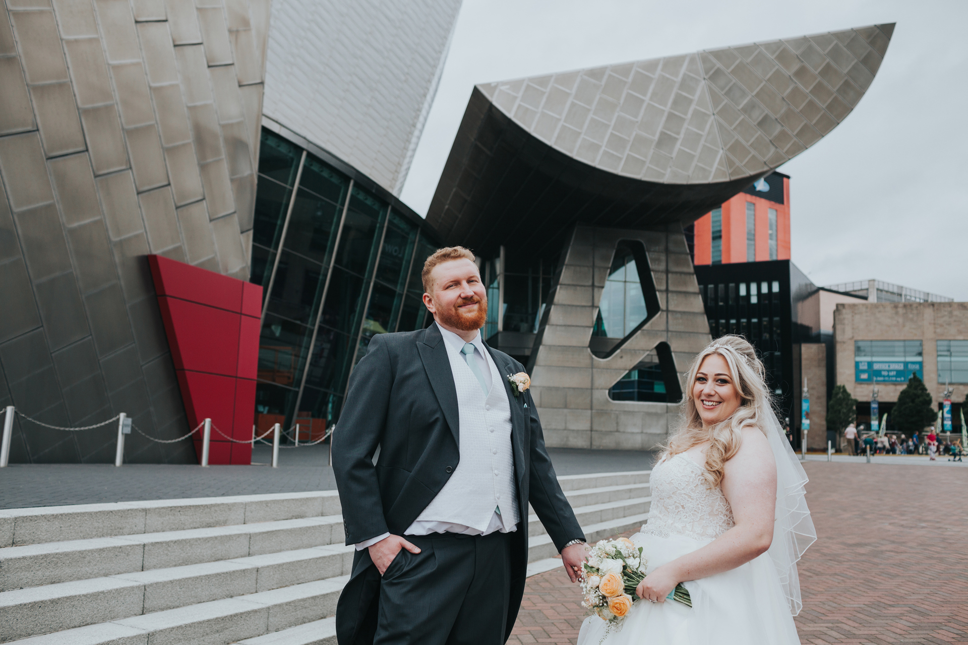 Bride and Groom with The Lowry Theatre behind them. 