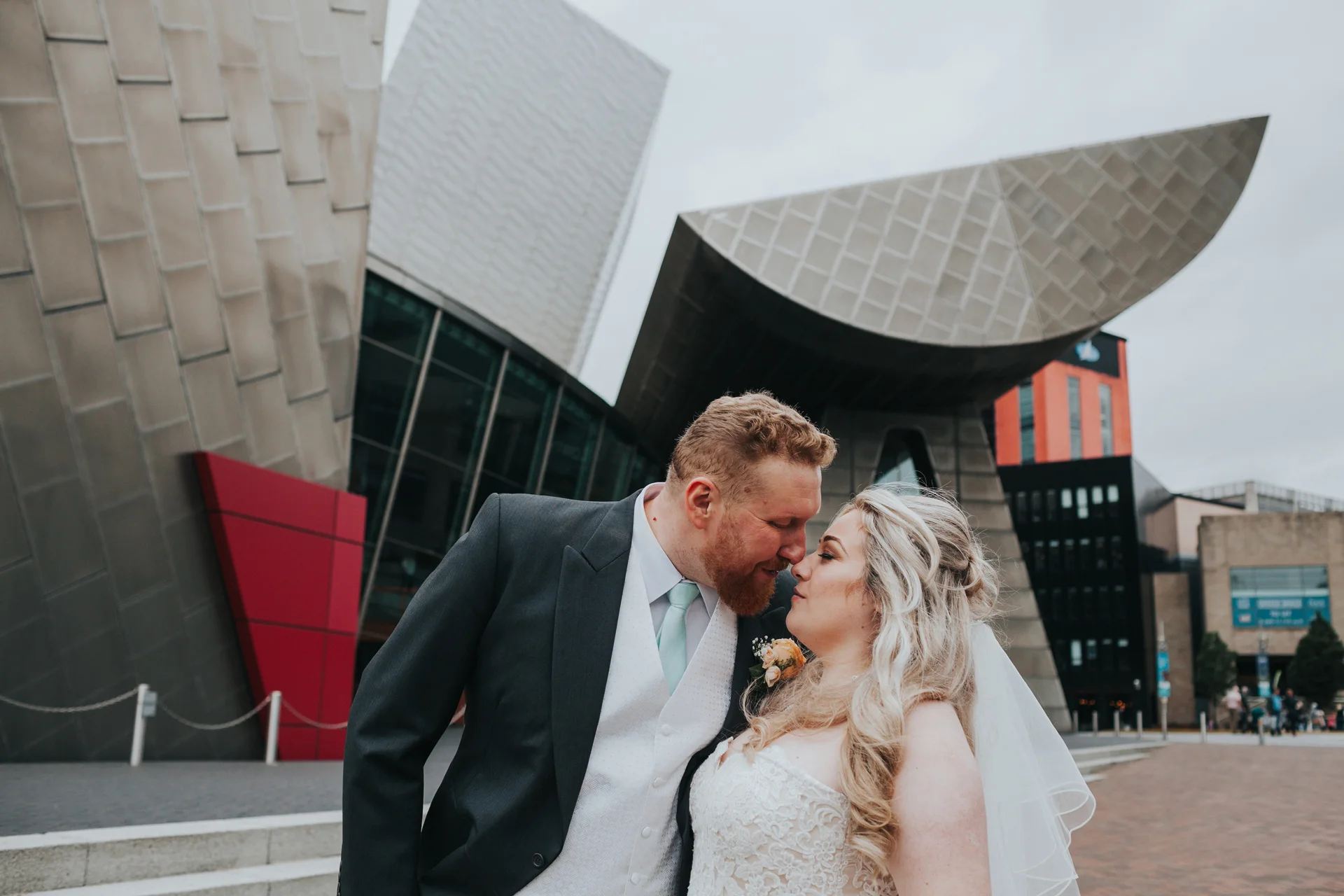 Bride and Groom go nose to nose outside the Lowry Theatre.