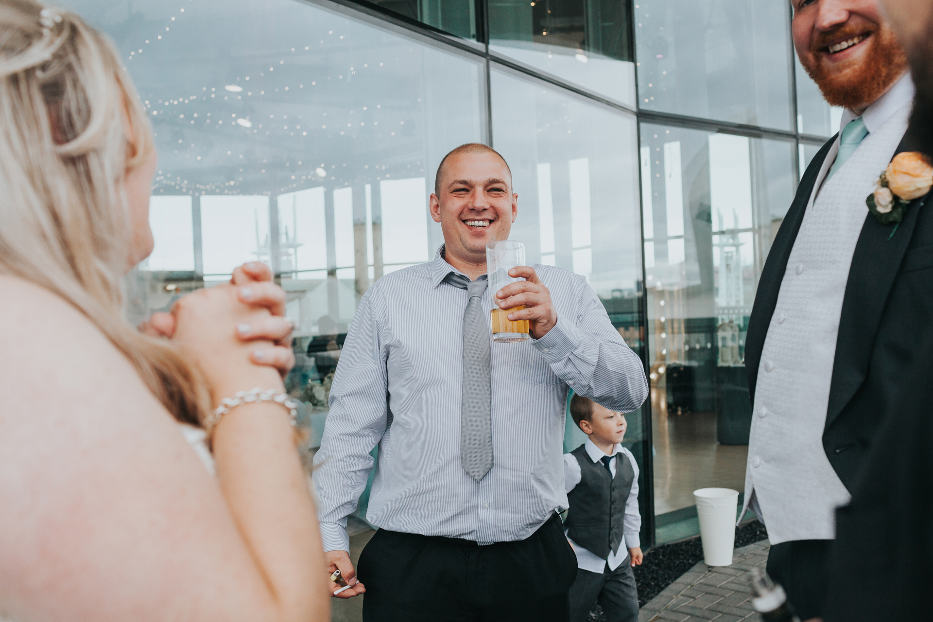 Wedding guests enjoy a drink. 