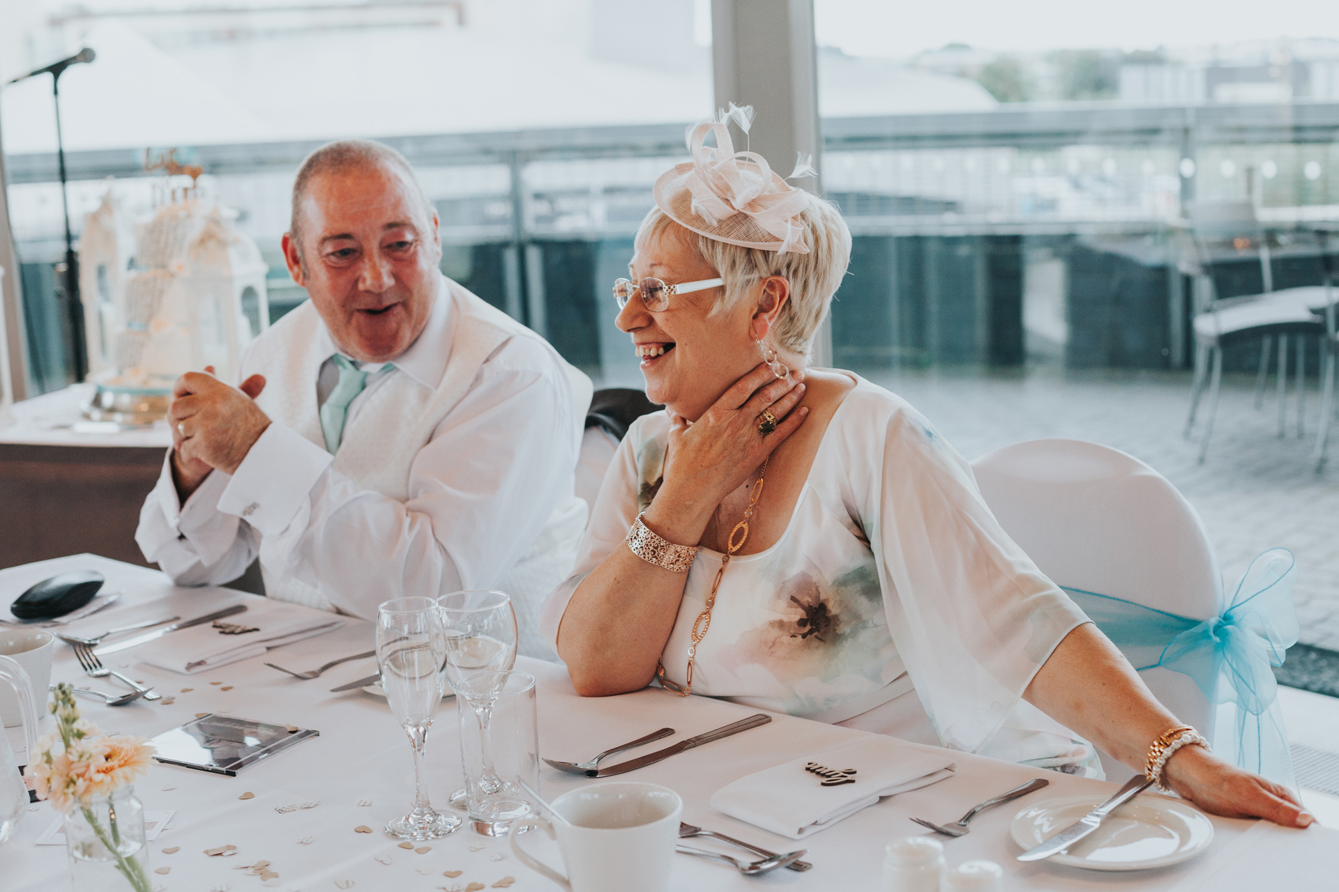 Mother of the bride has a laugh with father of the bride. 