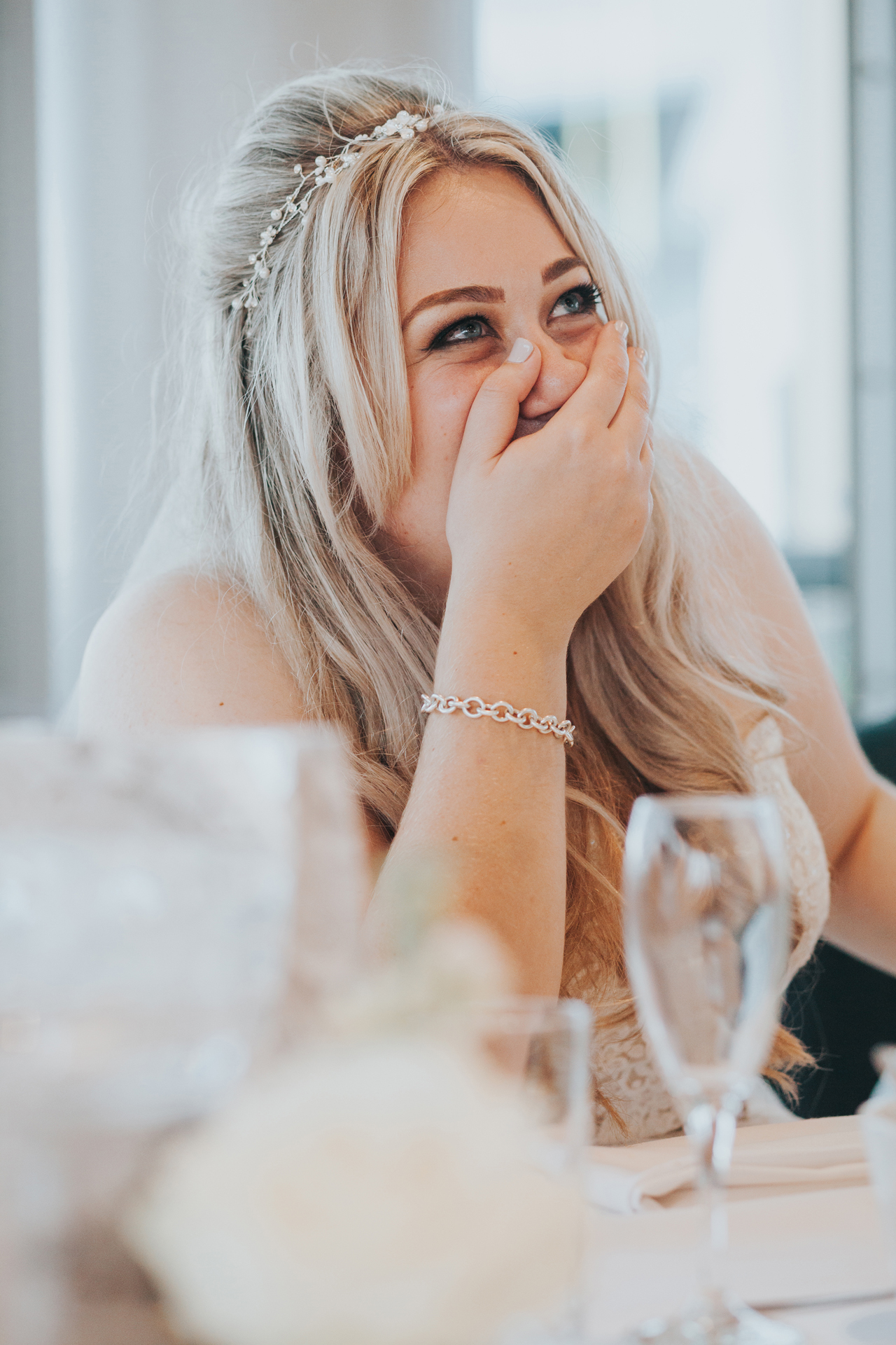 Bride laughing at Grooms speech. 