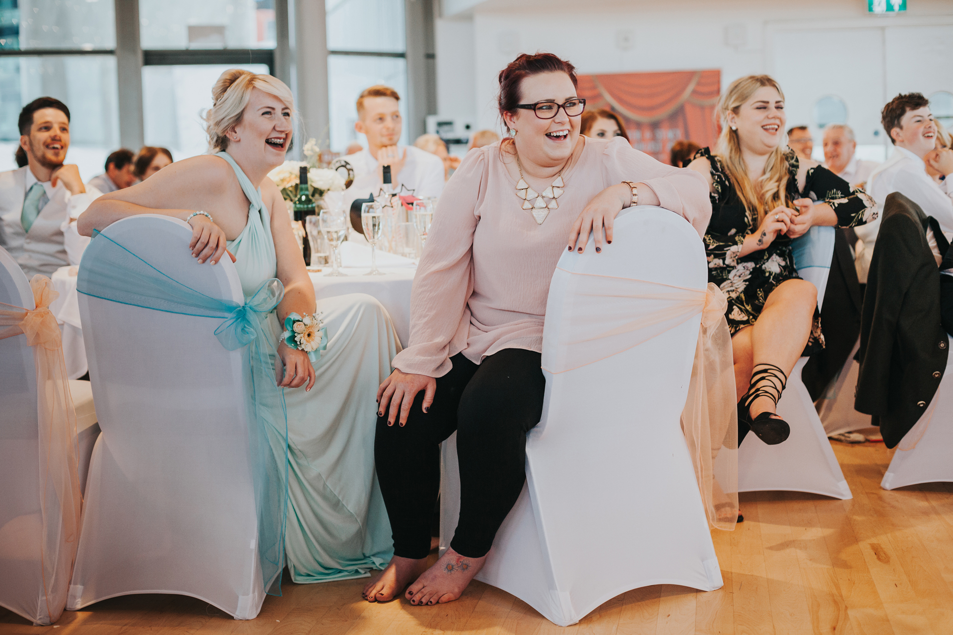 Wedding guests laughing. 