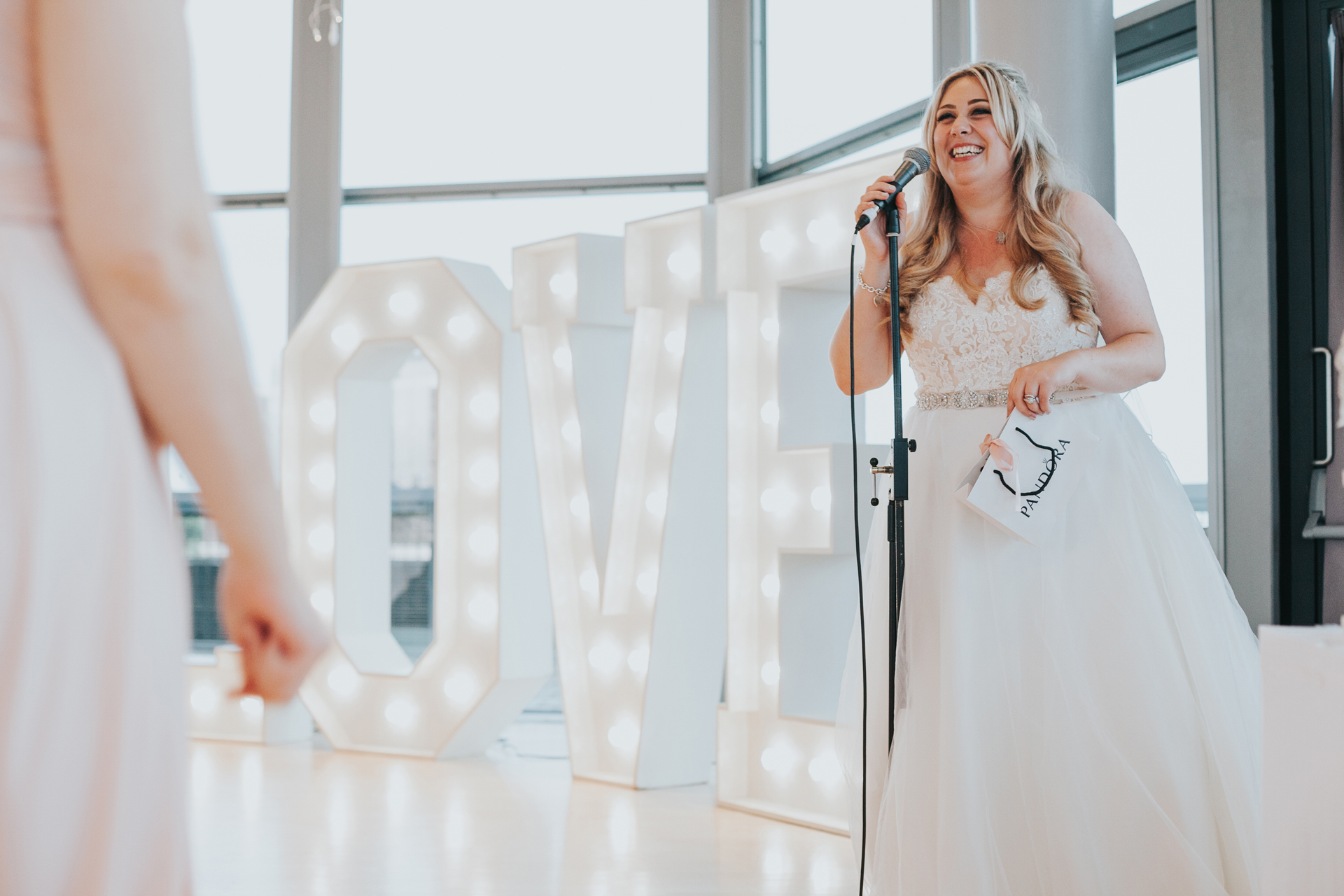 Bride stands up to say thanks yous. 