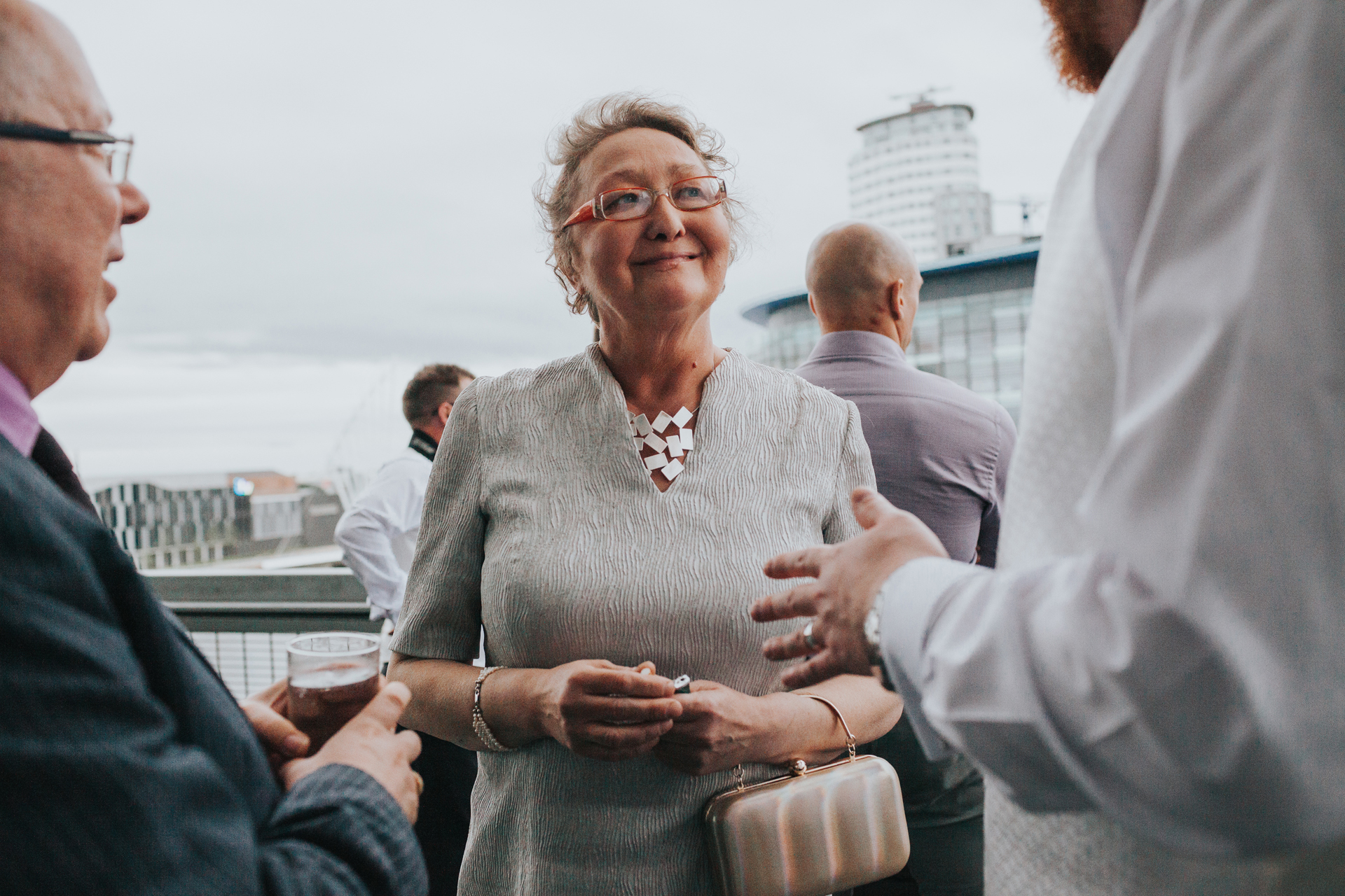Grooms mother looks happy.