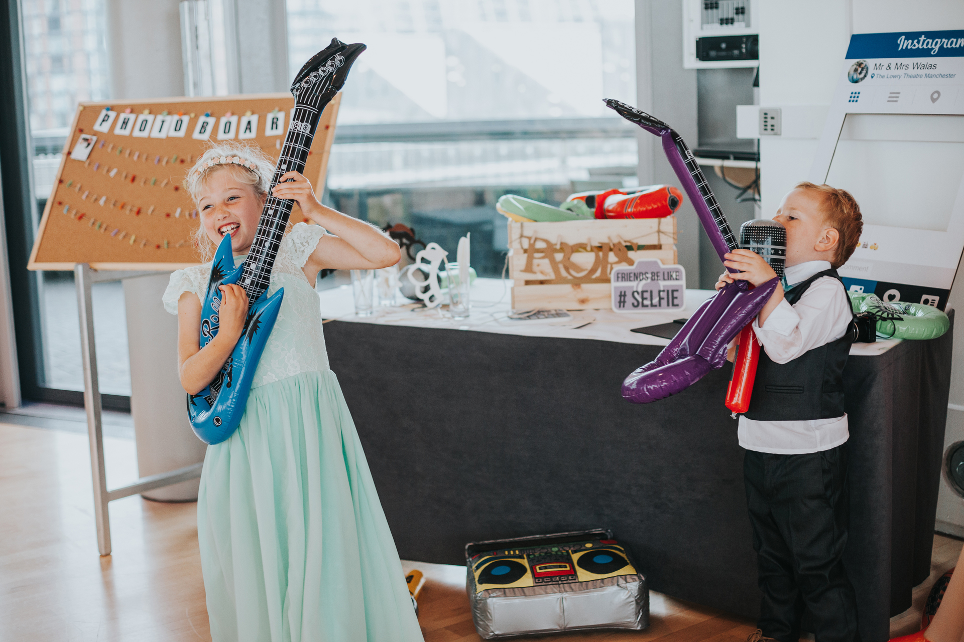 The kids find the inflatable guitars. 