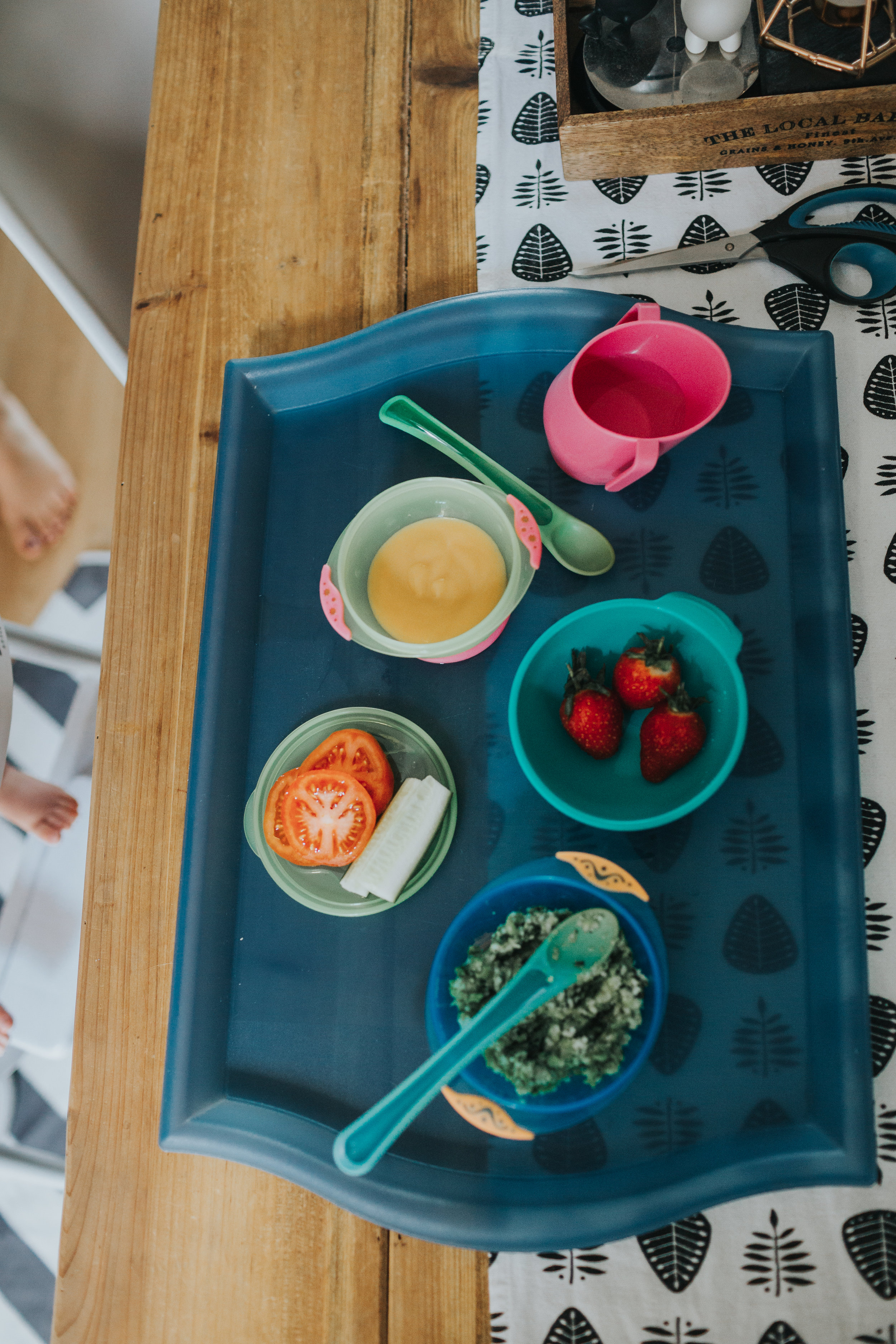 A photo of the babies lunch, strawberries, tomato, pea pure and unknown. 