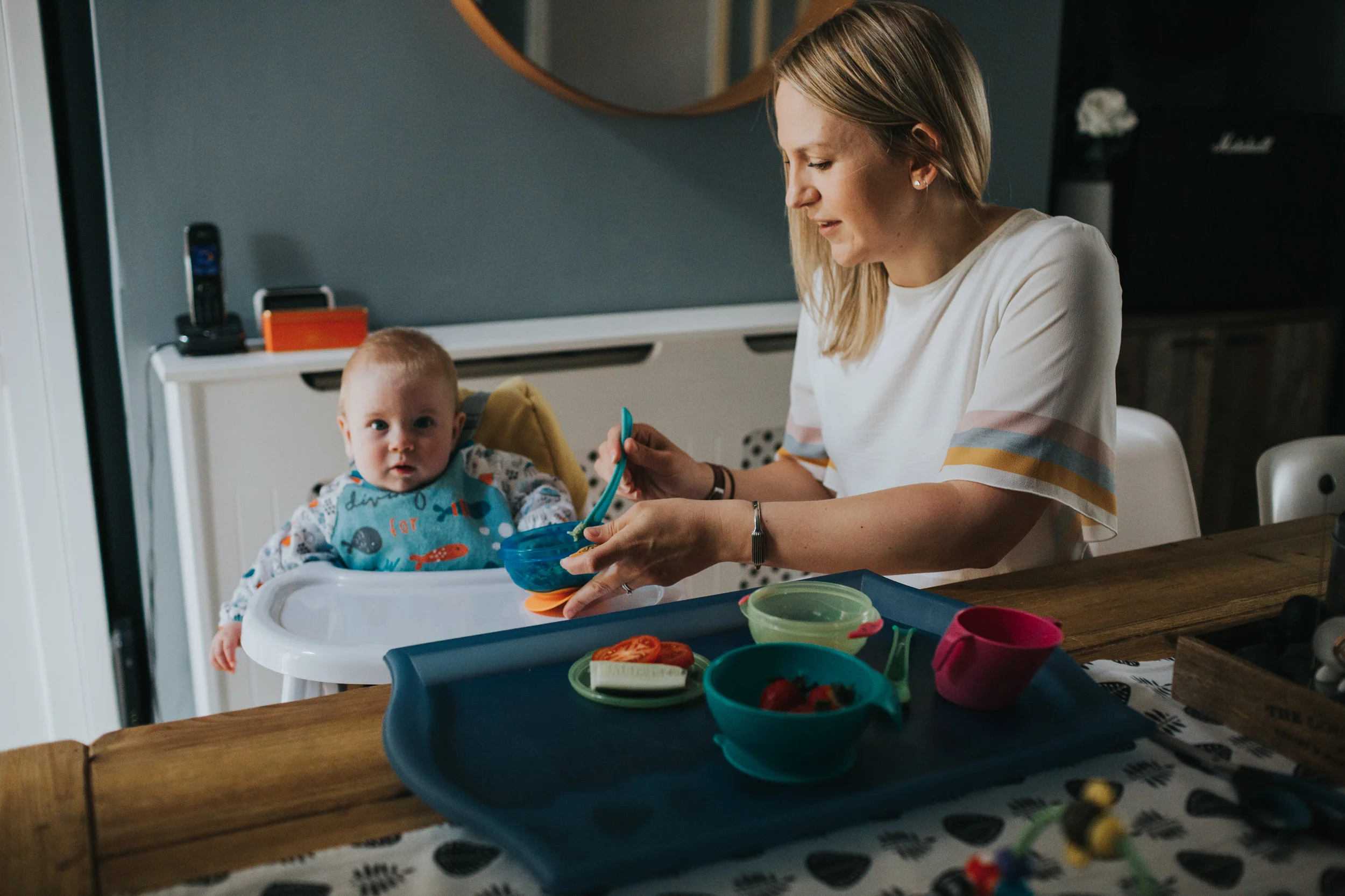 Mum feeding her baby at home. 