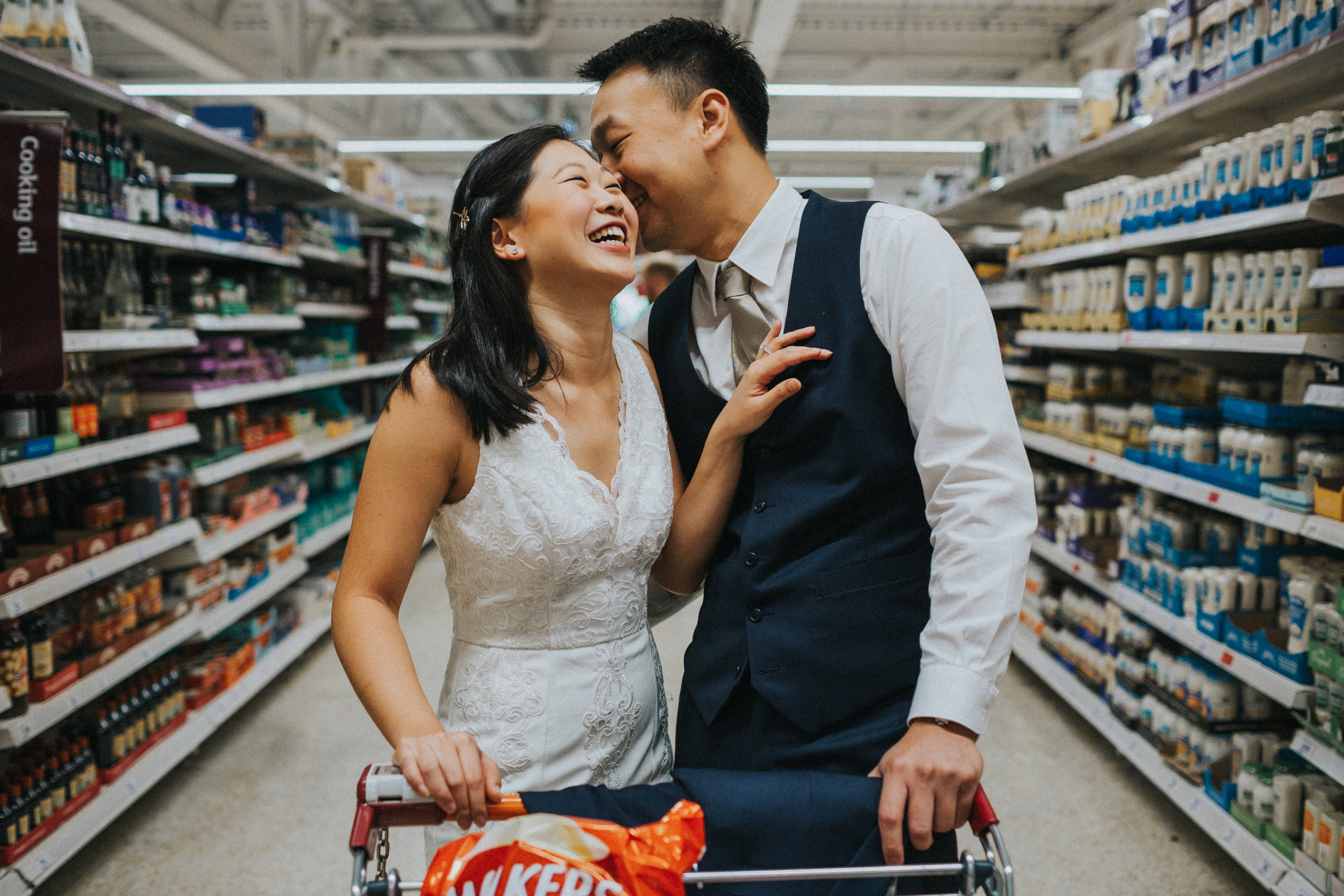 Couple laughing together in the supermarket. 