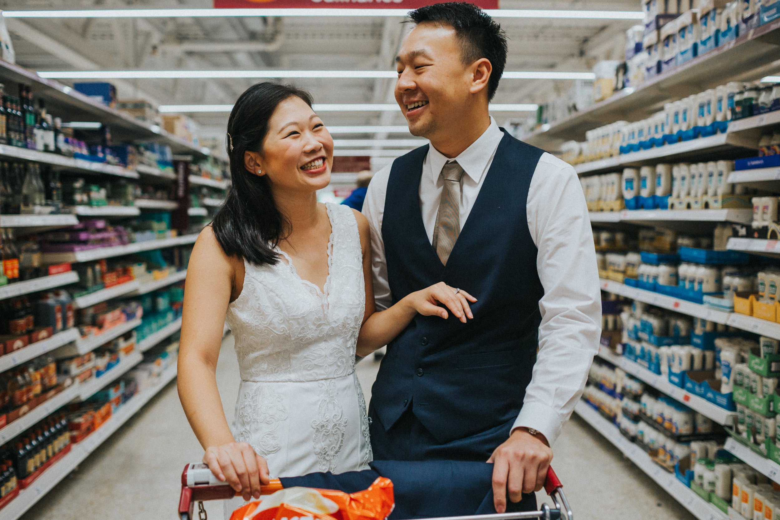 Couple smiling together in supermarket. 