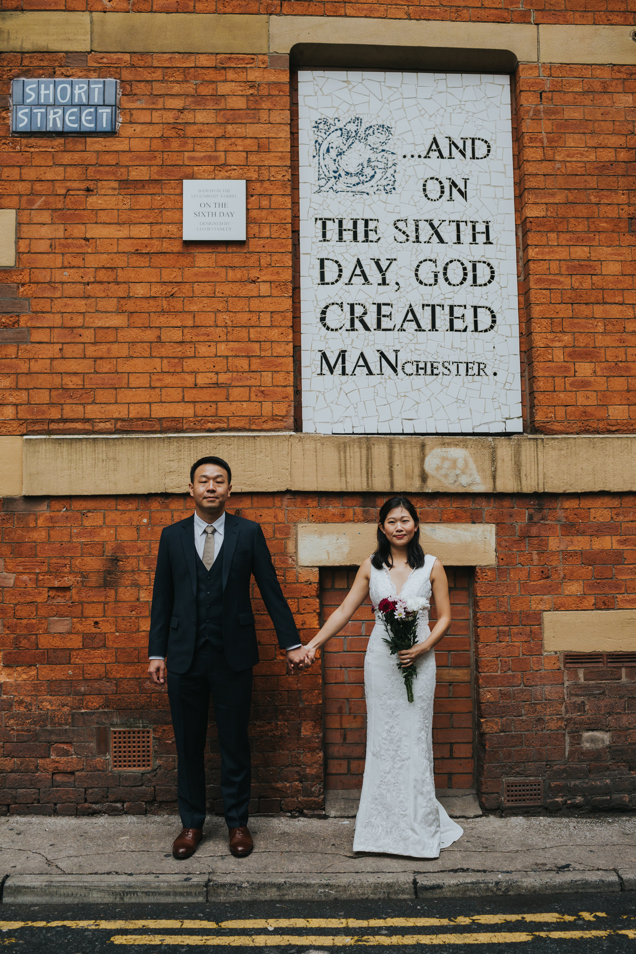 Couple hold hands outside of Aflecks Palace, Manchester.