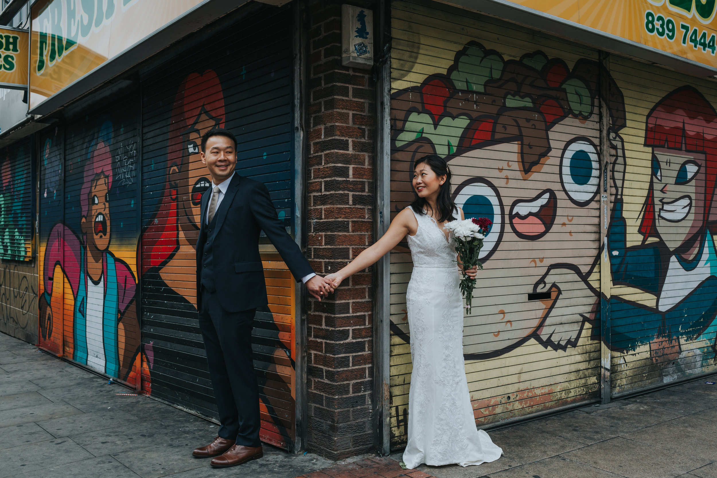 Couple standing outside Fresh Bites, Northern Quarter, Manchester.