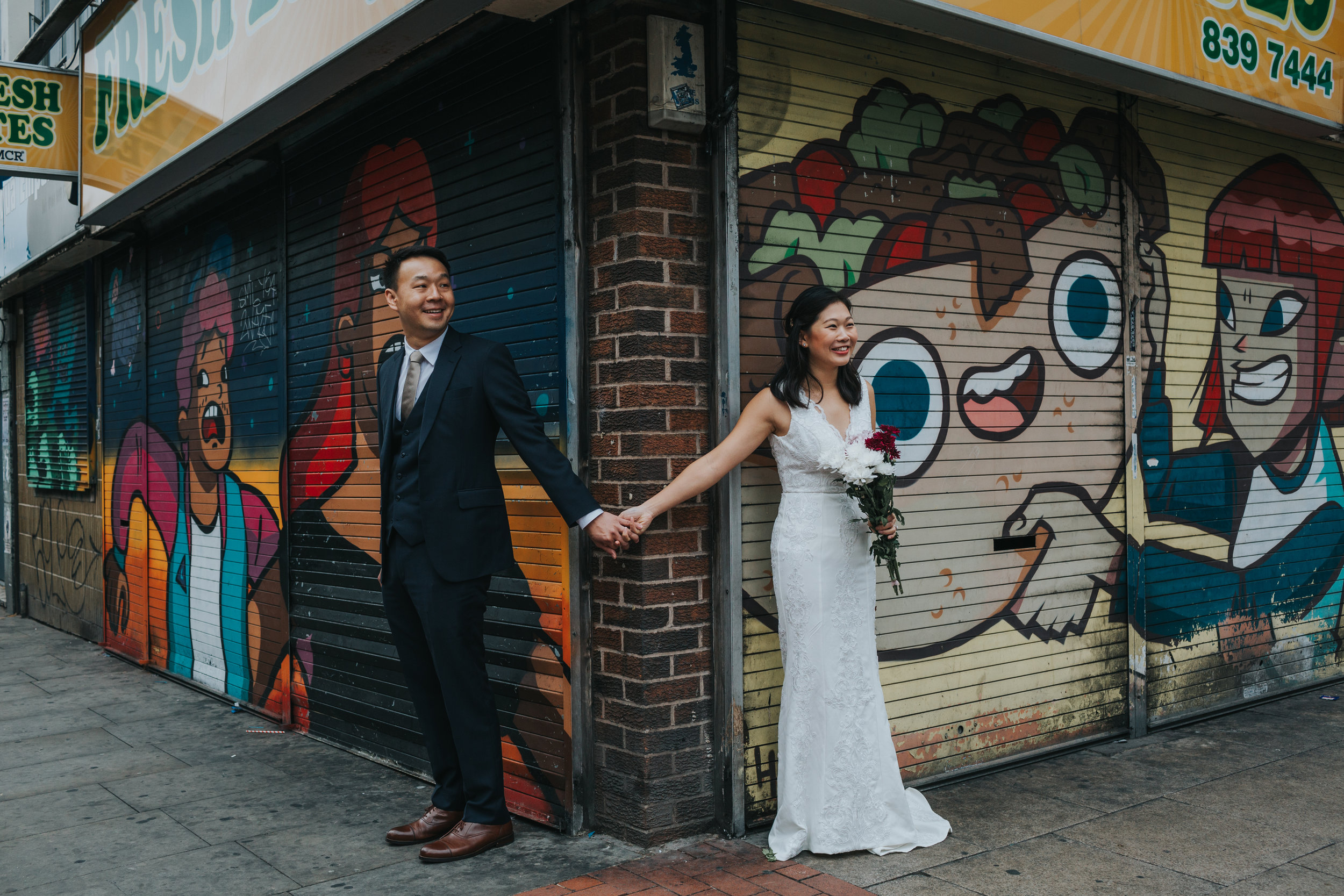 Couple Holding hands outside Fresh Bites take away in Manchester's infamous Northern Quarter. 