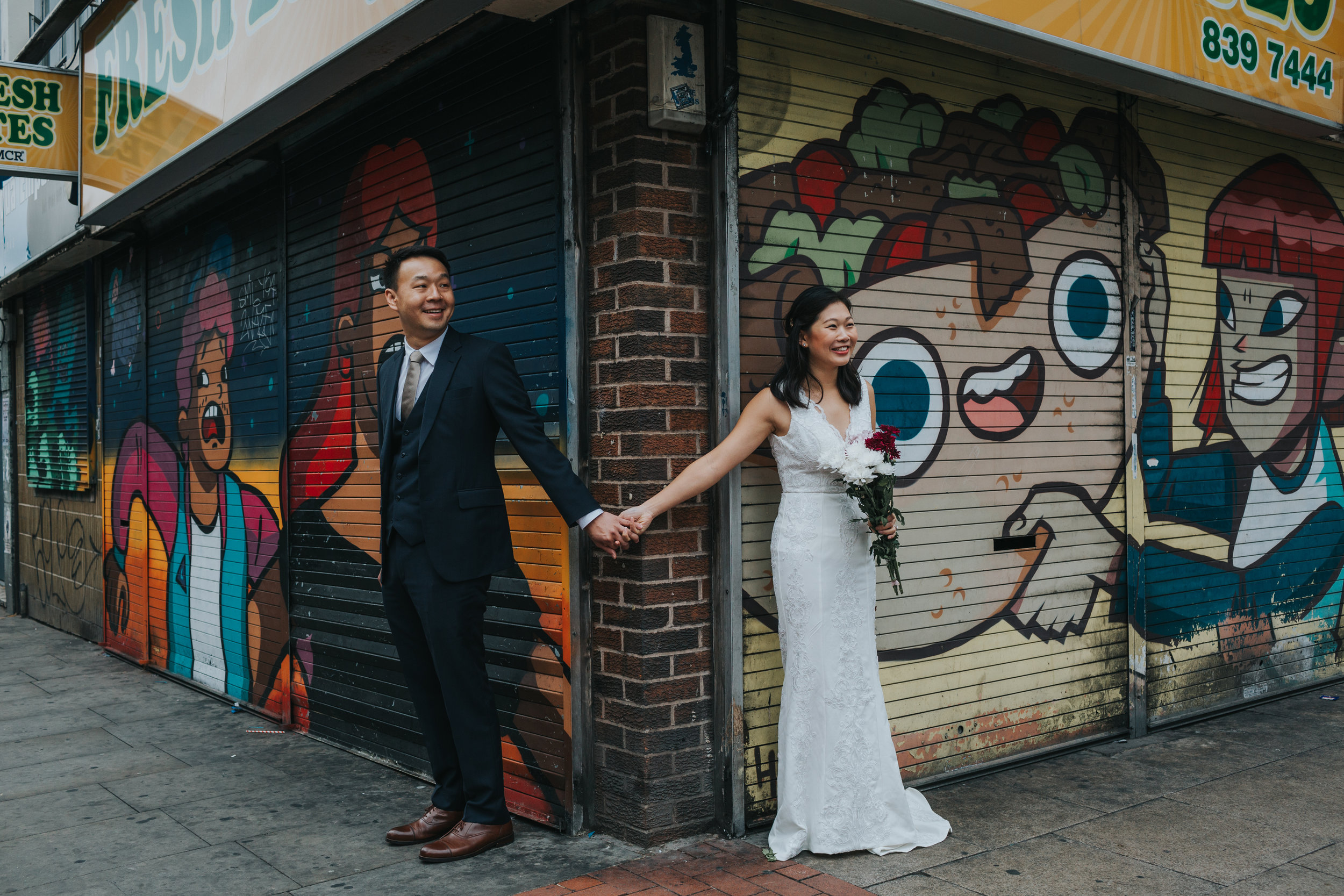 Couple Holding hands outside Fresh Bites take away in Manchester's infamous Northern Quarter.