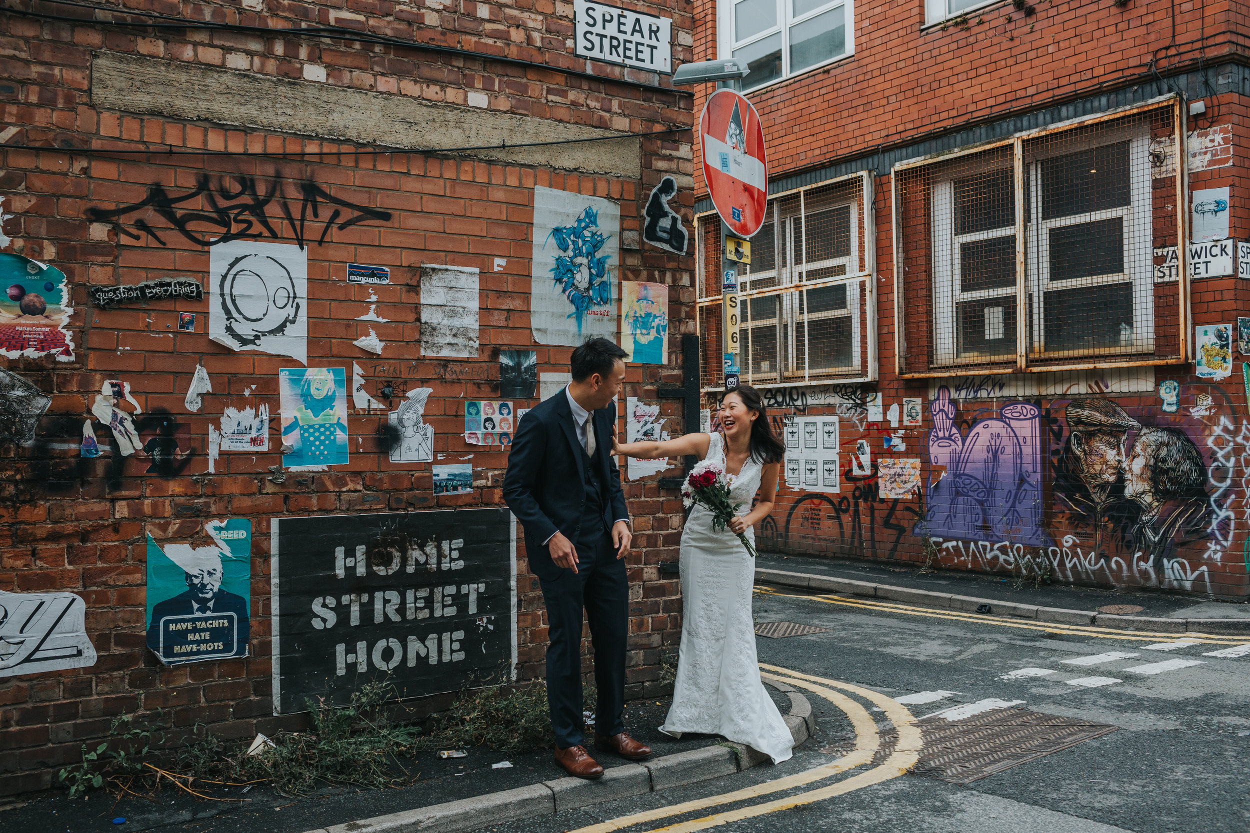 Bride pushes groom away laughing. 