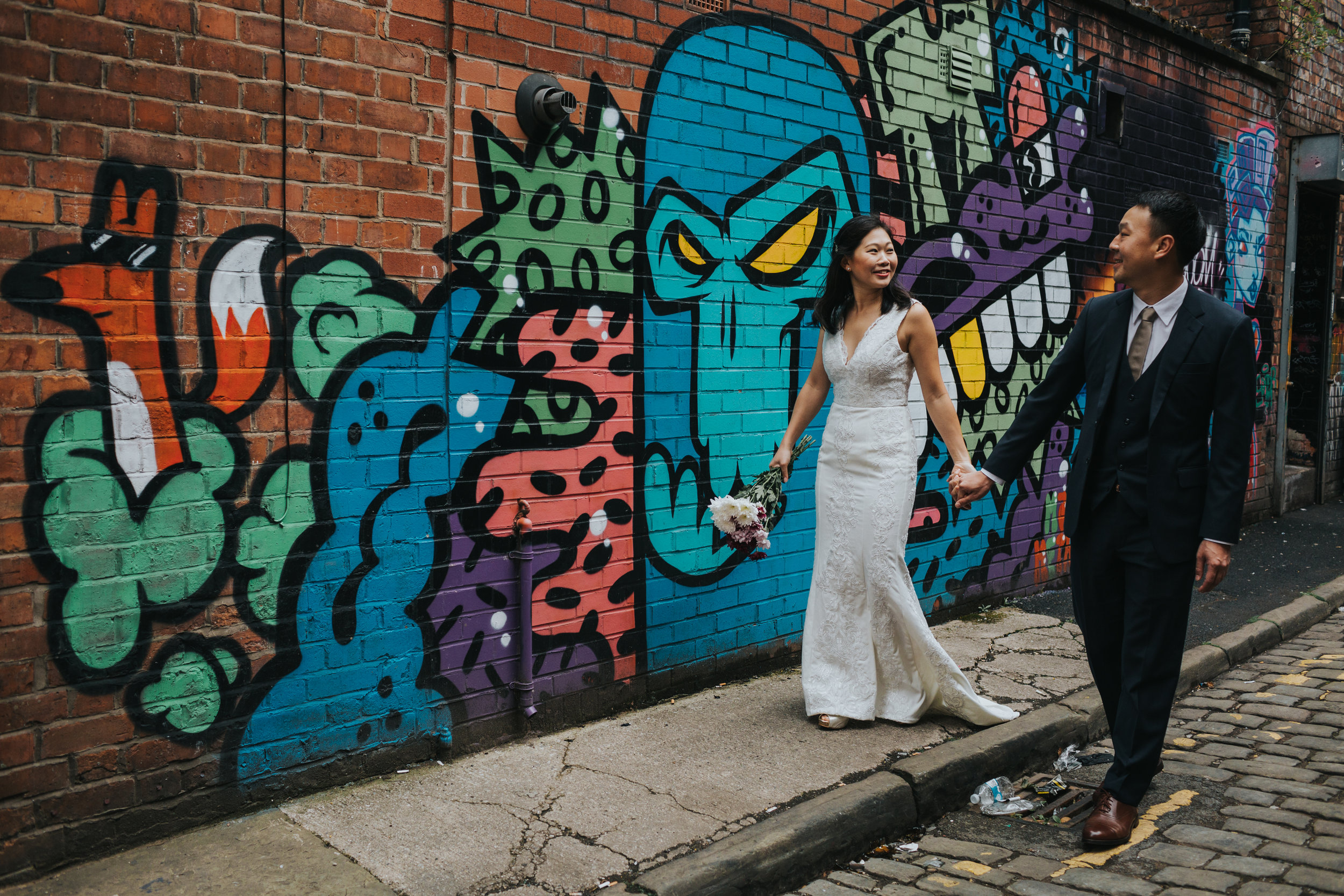 Couple walking together down an alley in Manchester. 