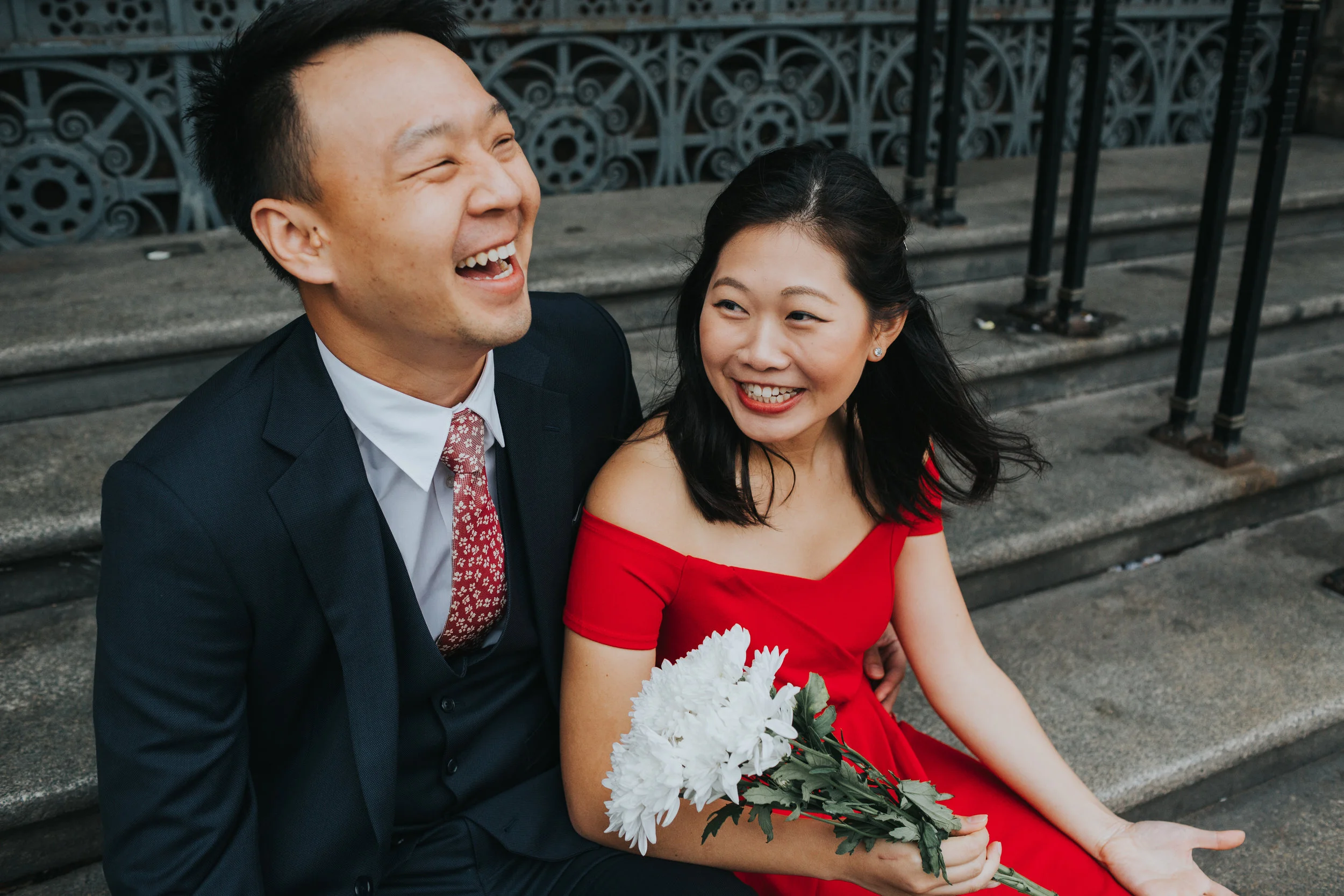 Couple laughing together on Manchester Town Hall Steps. 