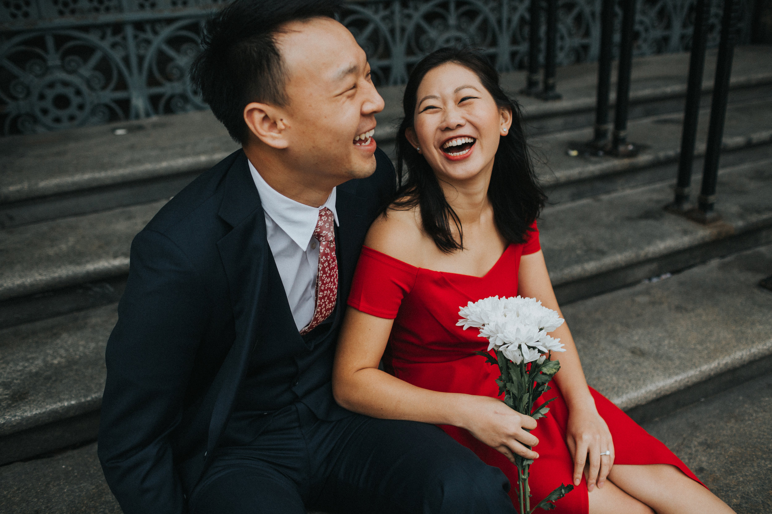 Couple sit and laugh together. 