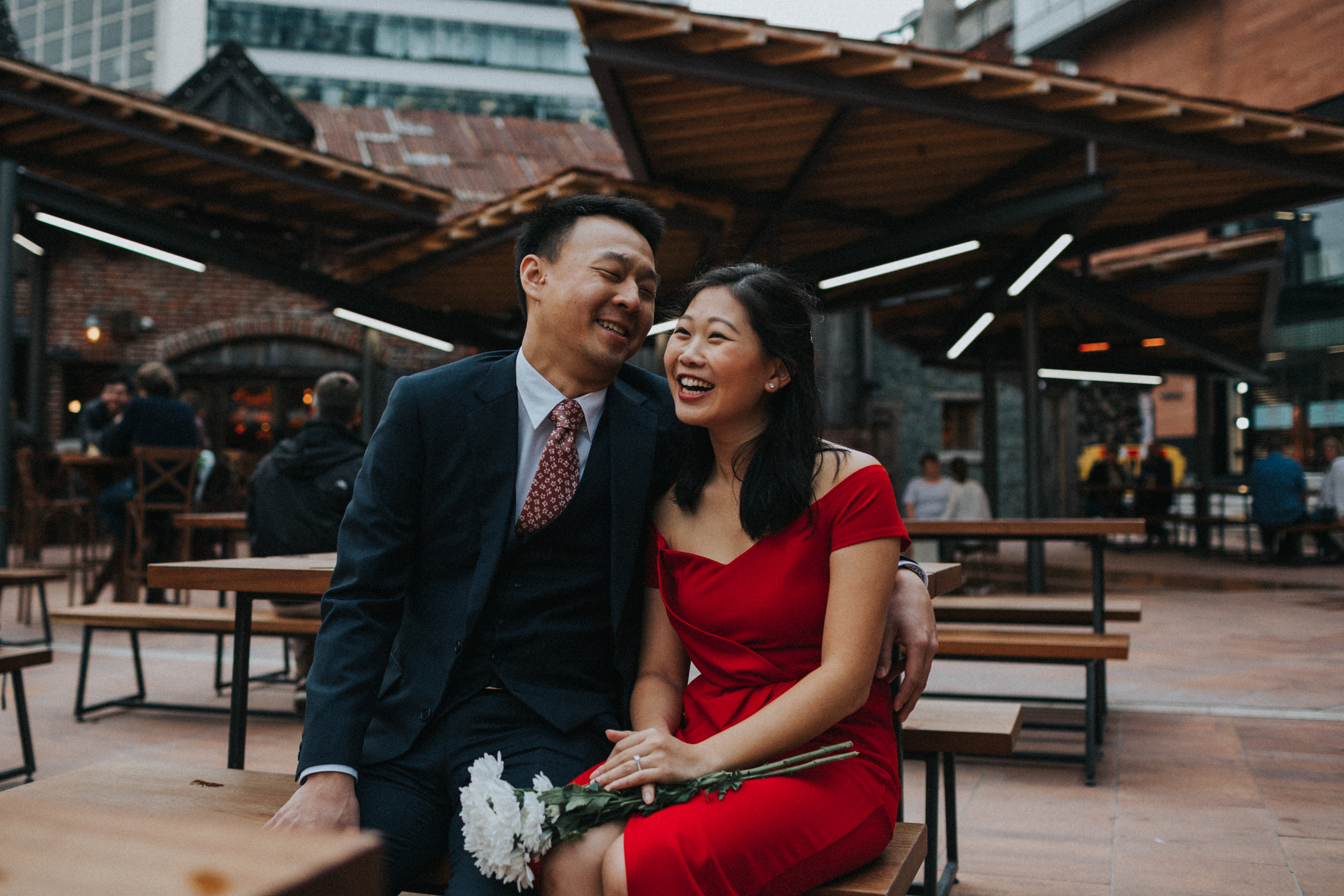 Couple laugh in Manchester beer garden.