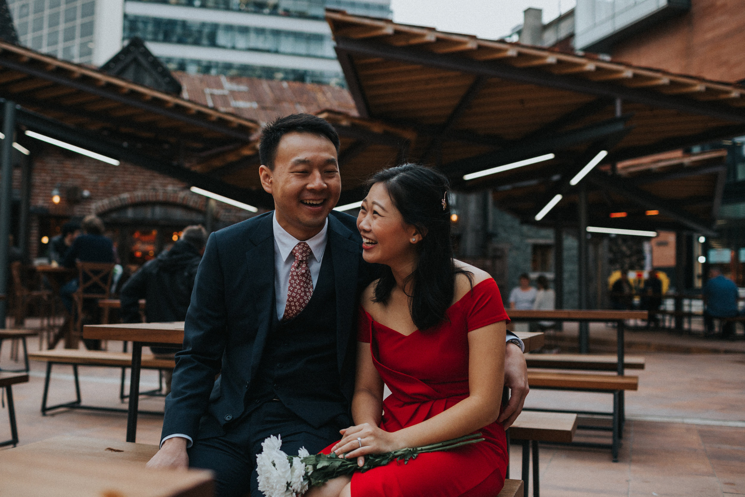 Couple enjoy time together in a modern beer garden in Manchester City Centre. 