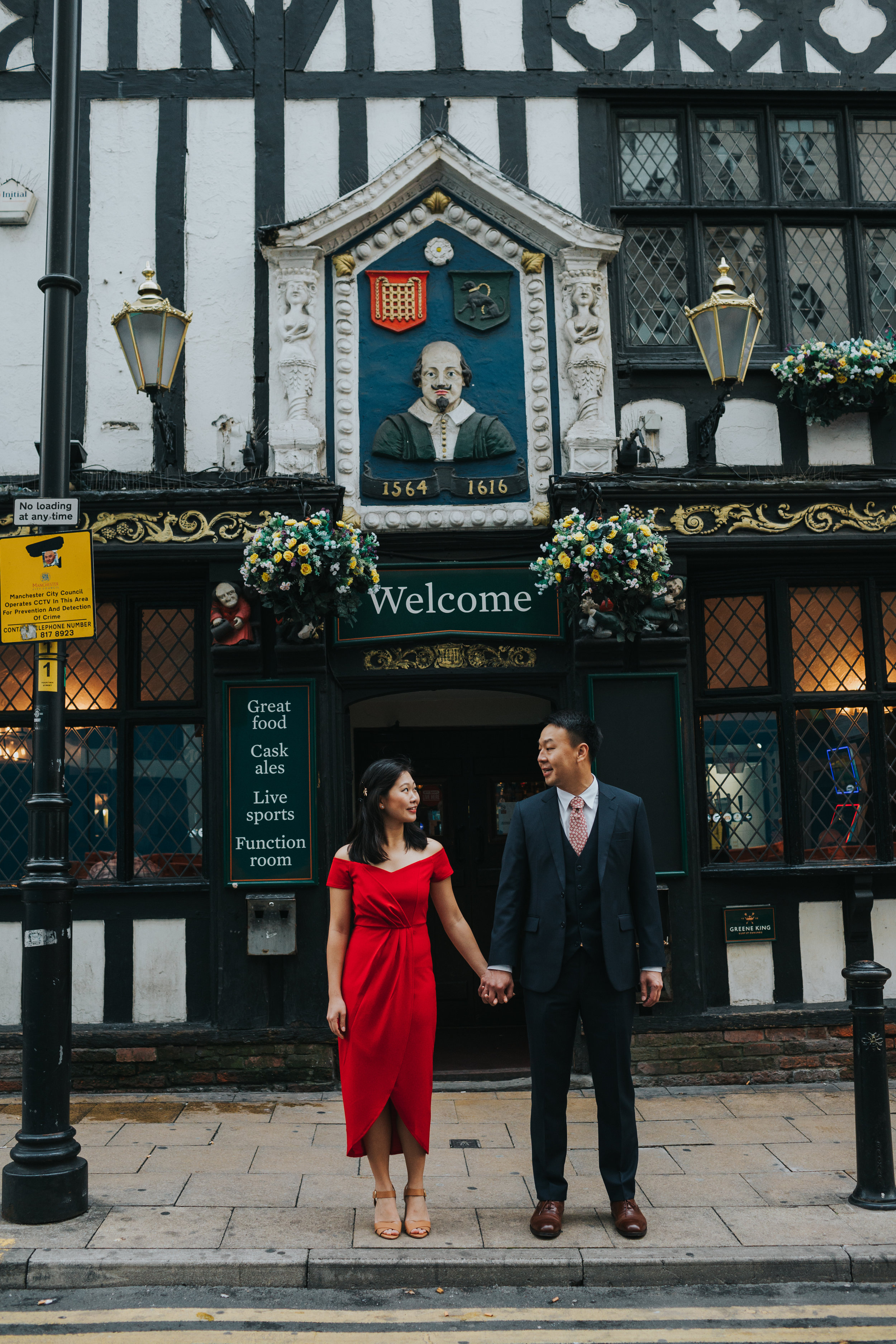 Couple stand outside Shakespeare pub Mancheseter. 