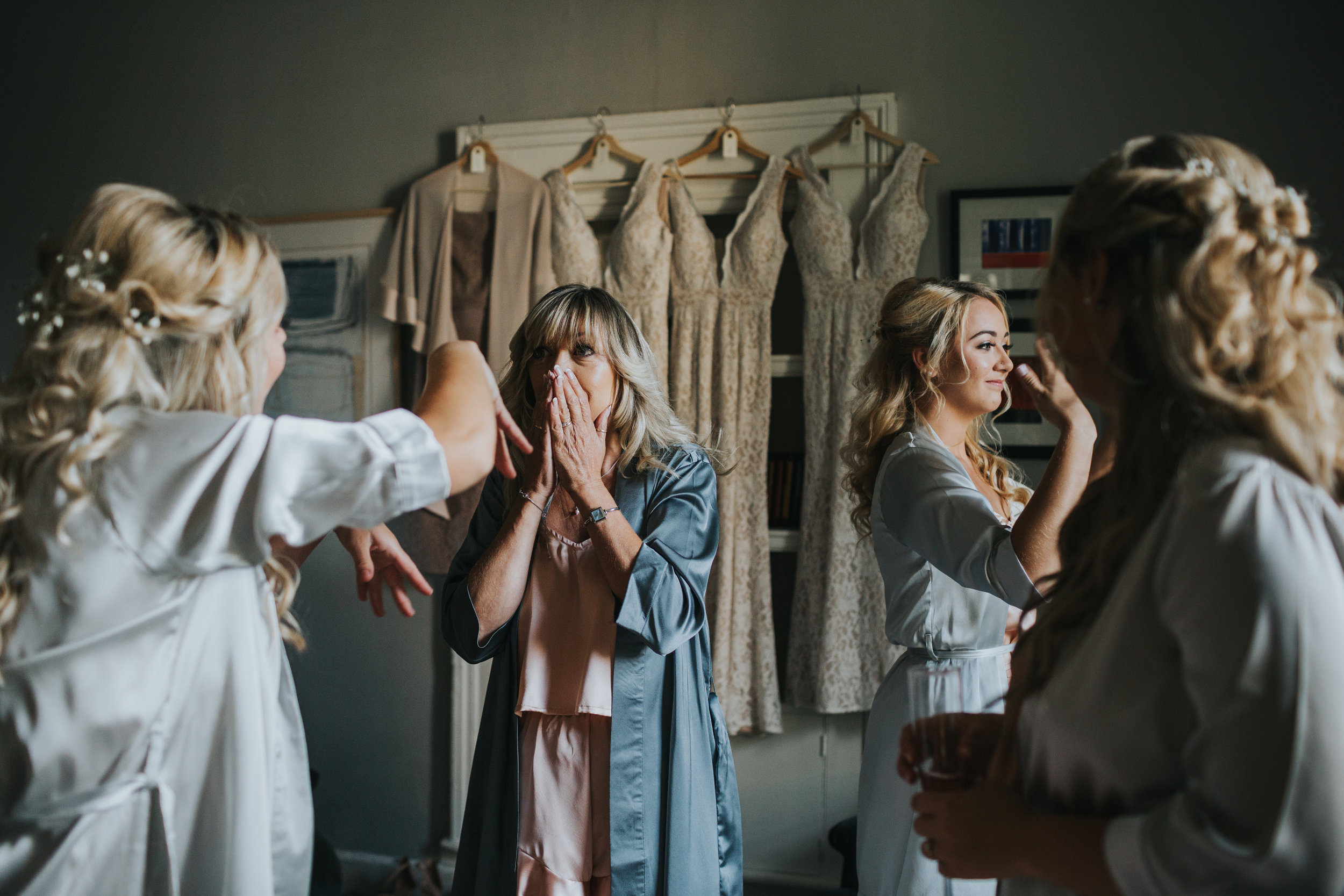 Mother of the Bride and Sister of the Bride have a moment together as they look at the bride getting ready at Cotswolds House Hotel.