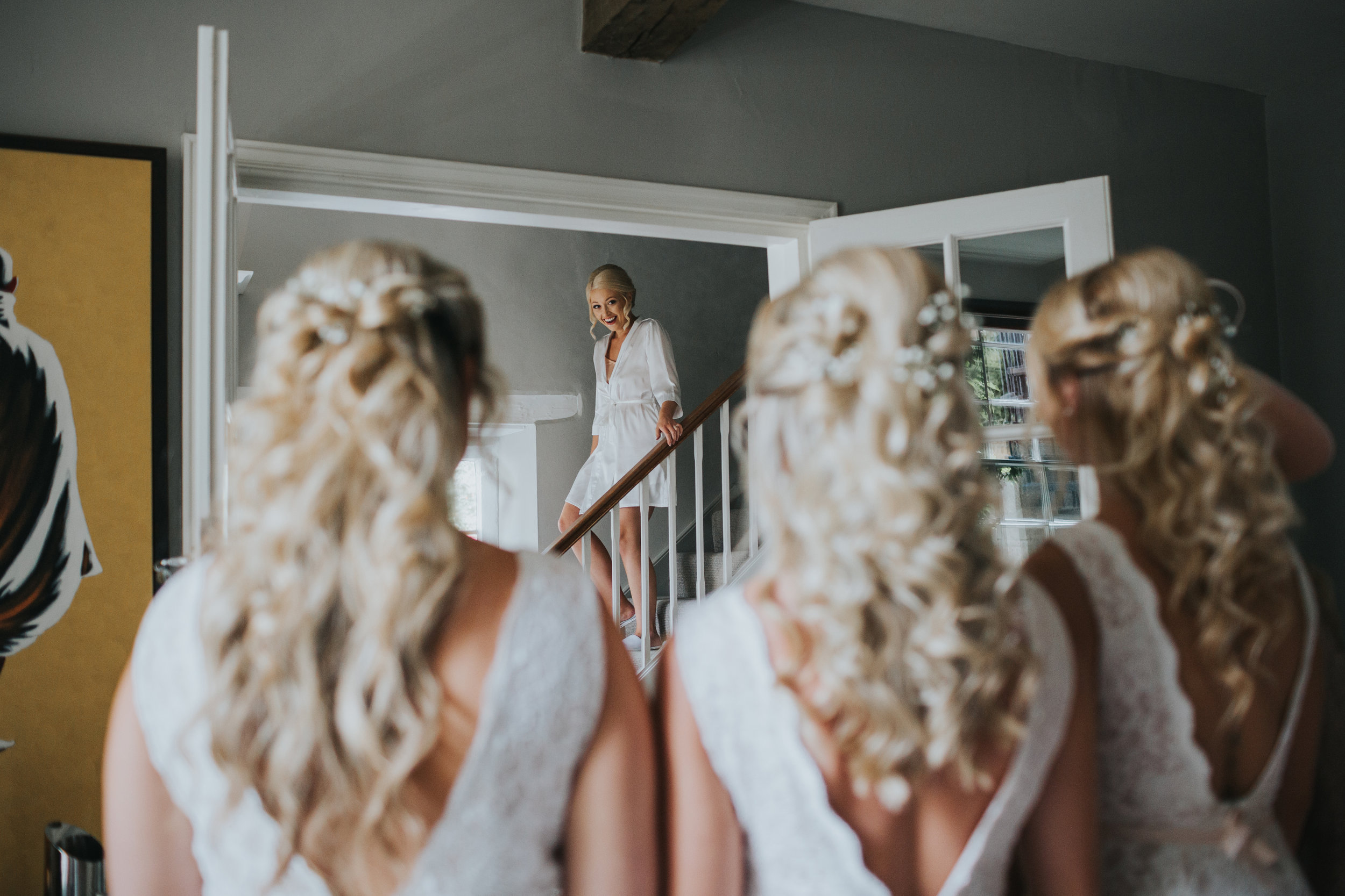 Bride comes down to see her bridesmaids in their dresses for the first time.  (Copy)