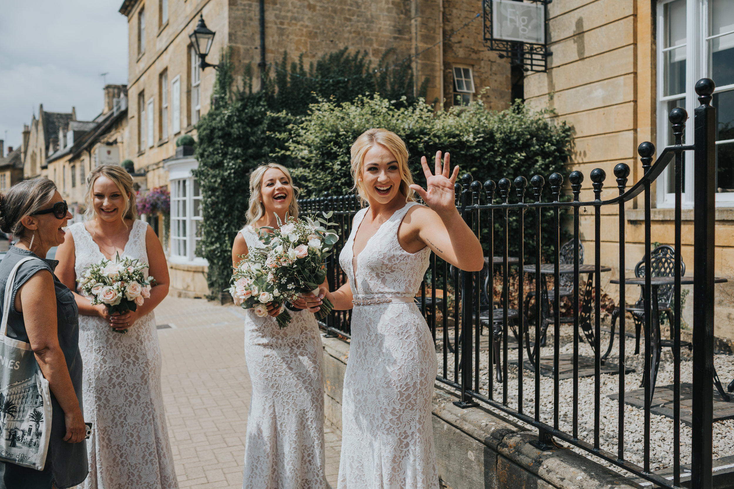 Bridesmaids waving outside The Cotswolds House Hotel.