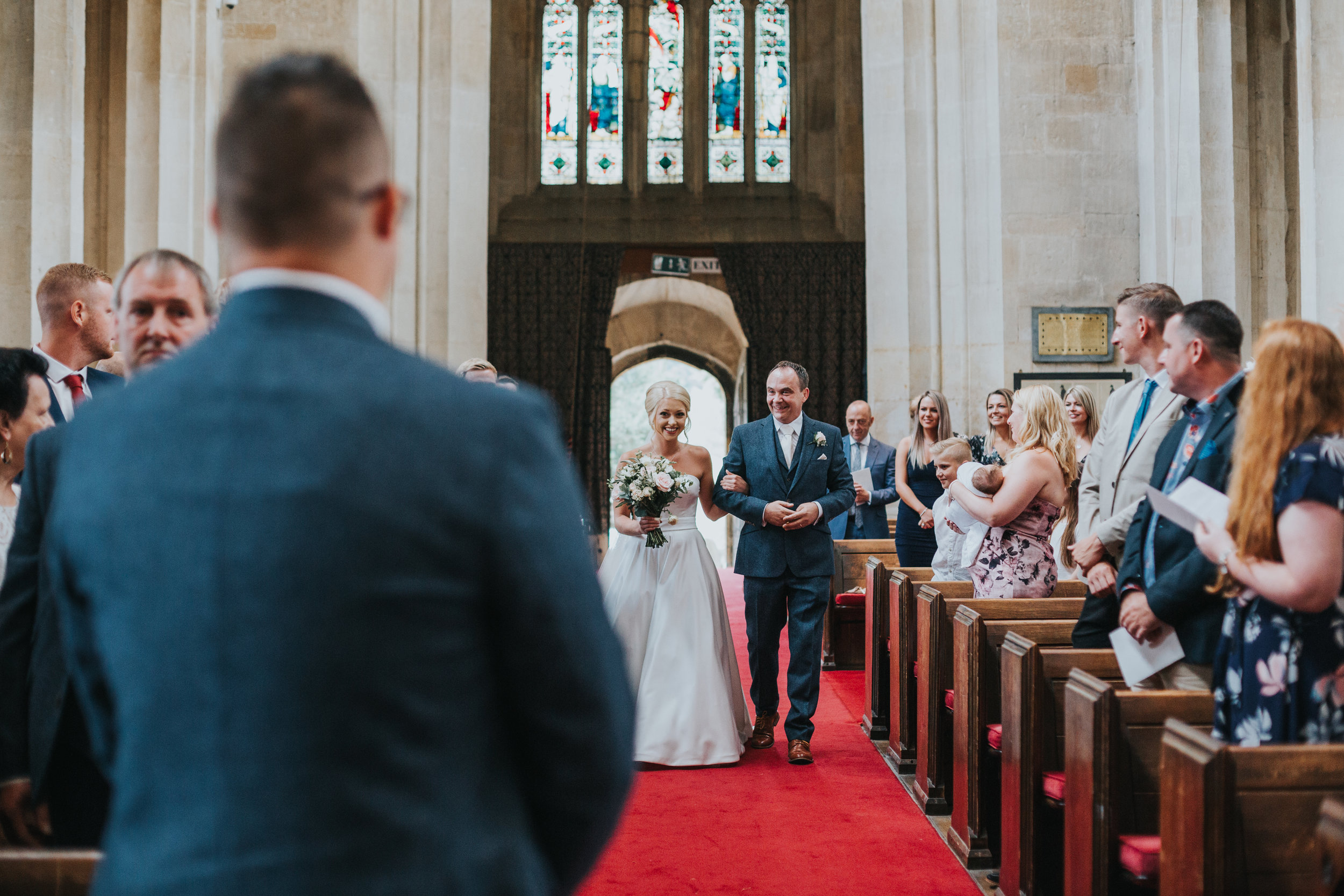 Bride and Father of the Bride walking down the aisle in St James Church in Chipping, Campden.  (Copy)