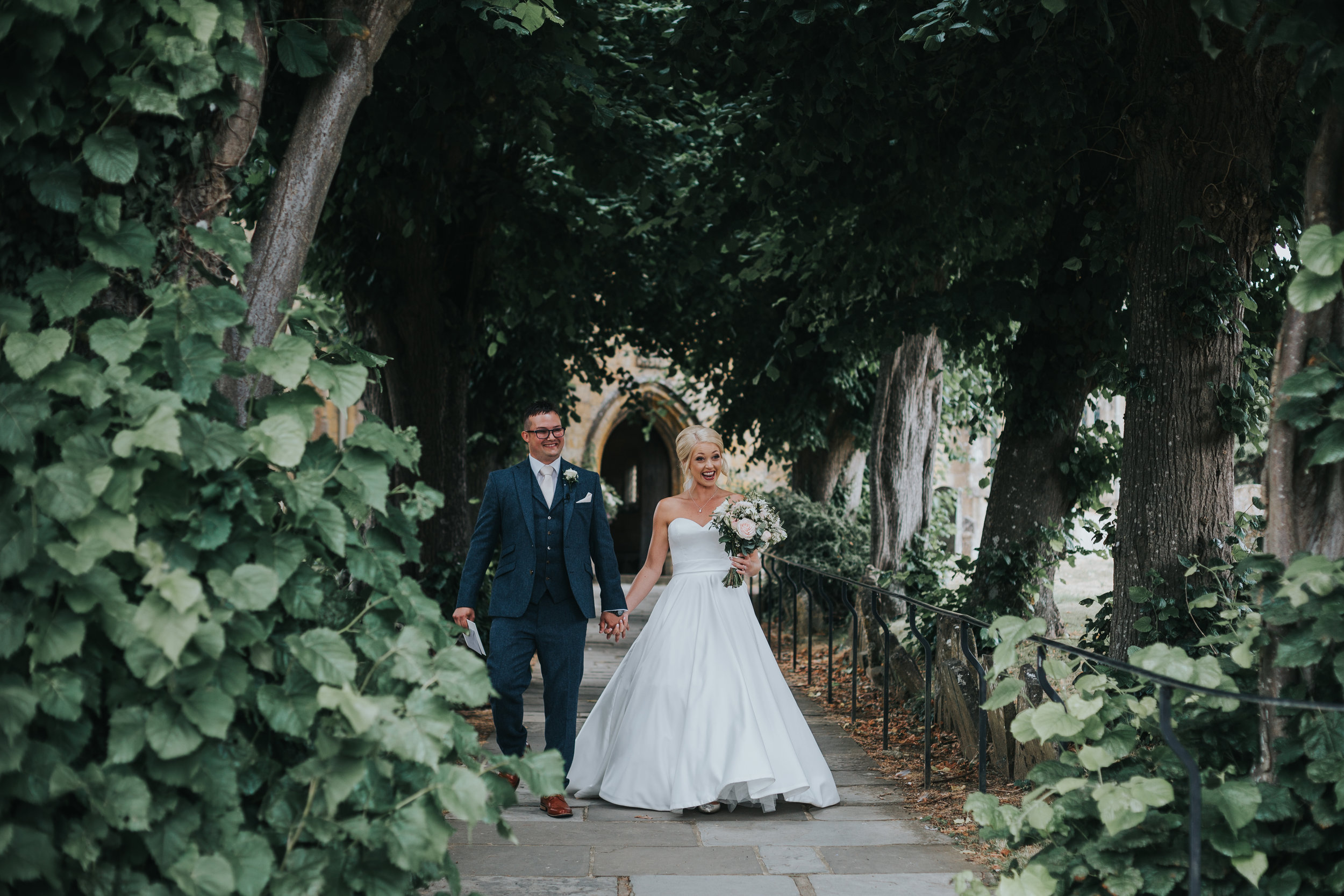 Bride and Groom walk down the church path towards their guests.  (Copy)