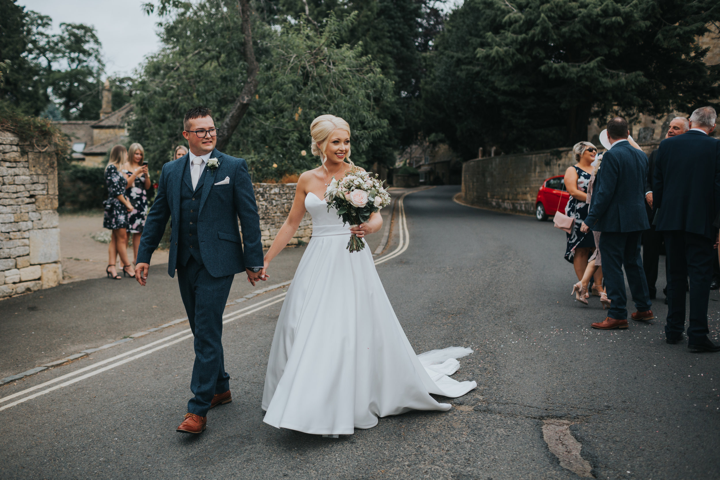 The bride and groom lead their guests away from the church.  (Copy)