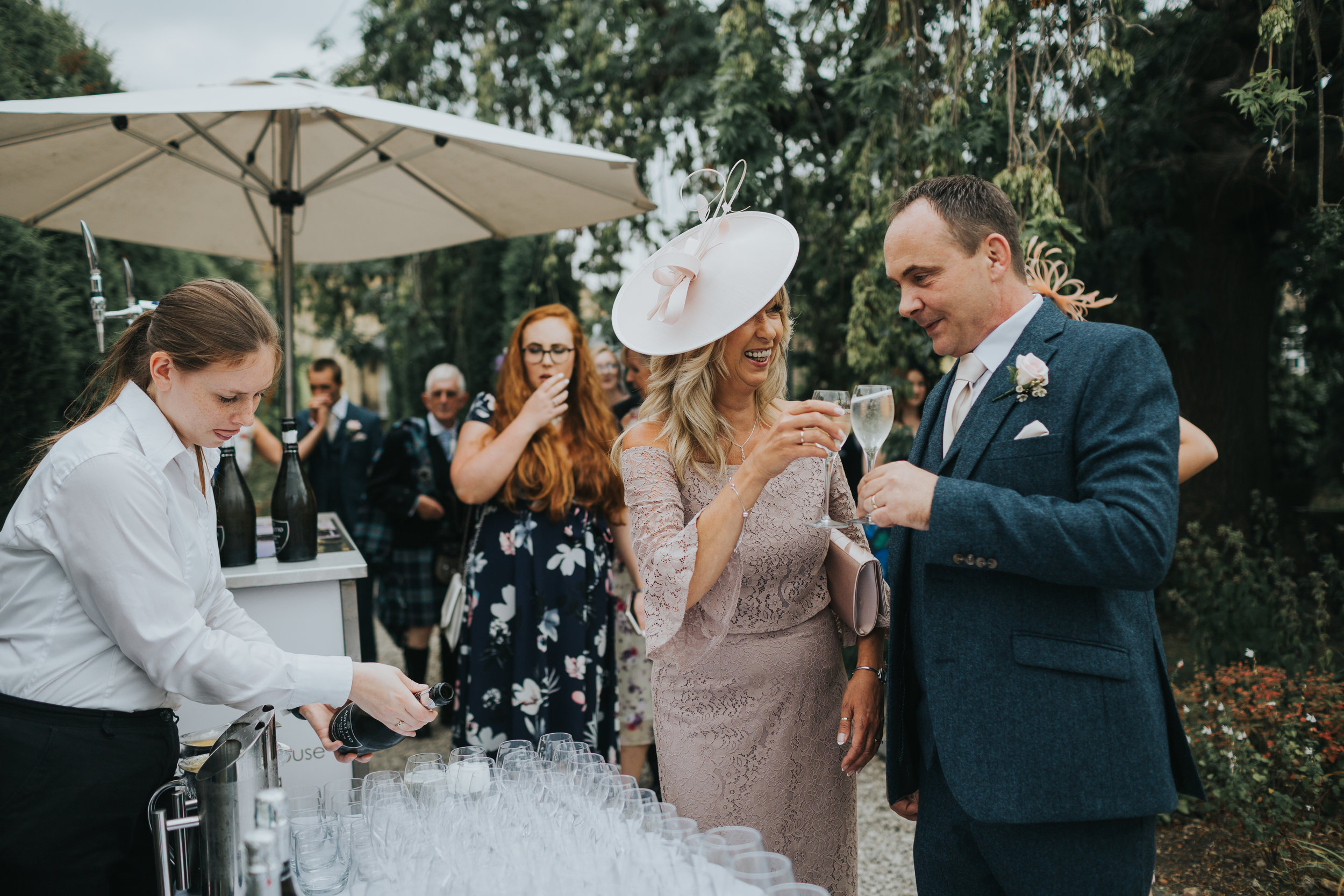 Mother and Father of the Bride Cheers each other with champagne at the bar.  (Copy)