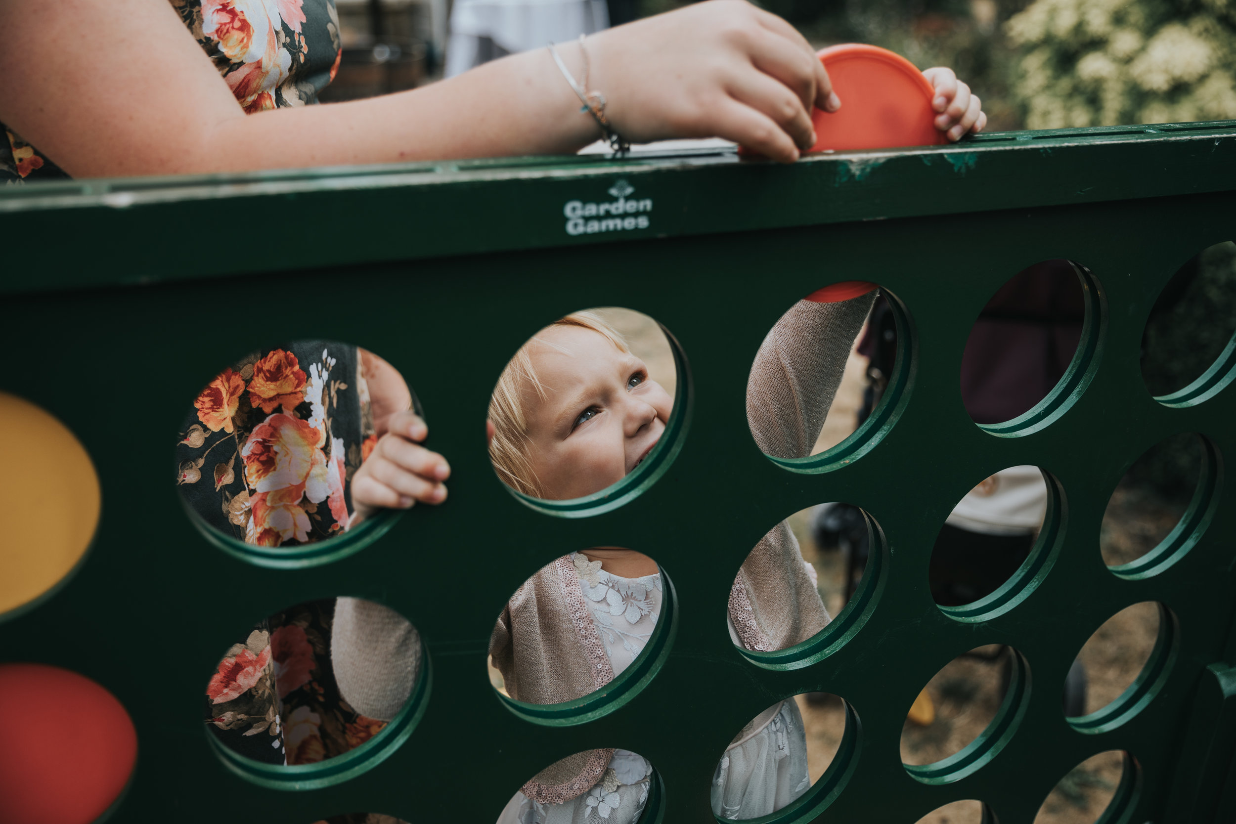 Little girl plays connect 4 shot through holes.  (Copy)