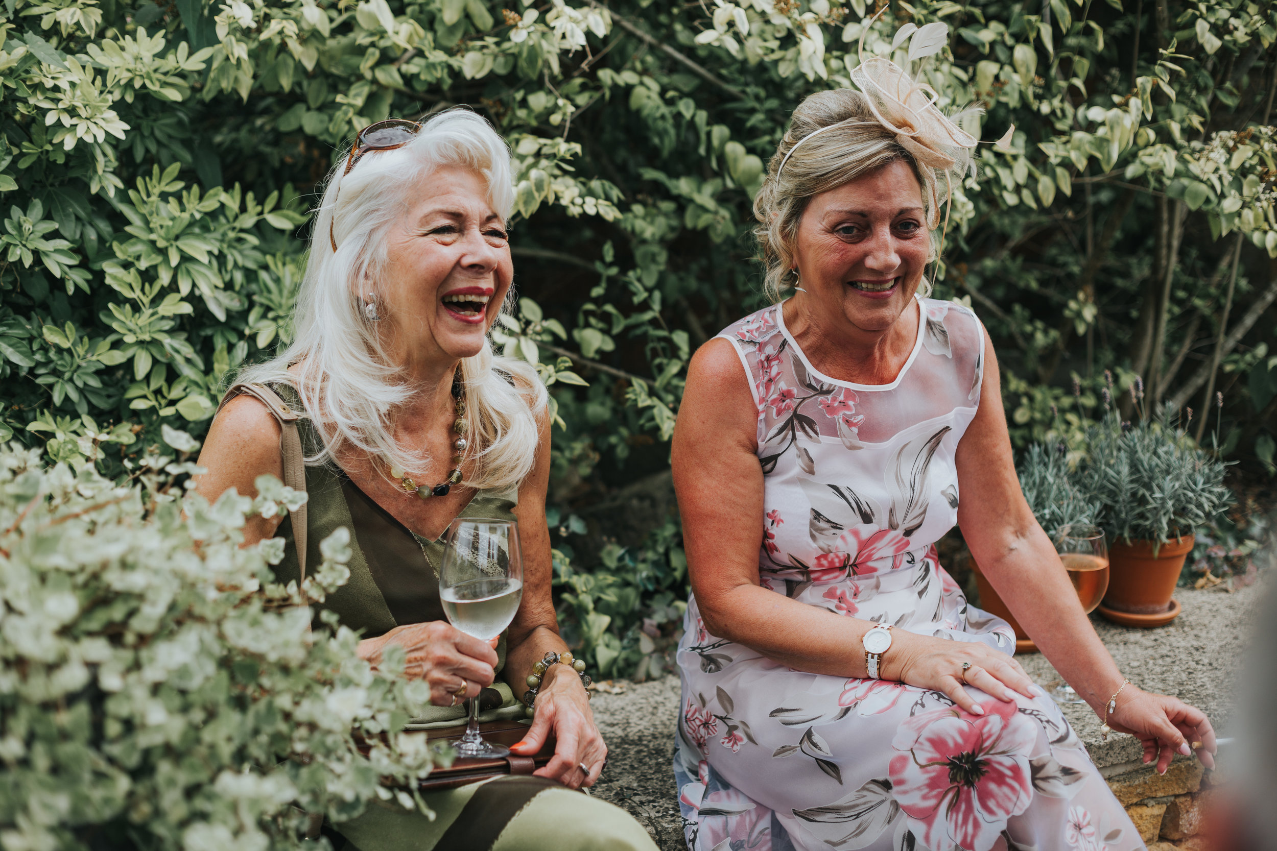 Wedding Guests laughing in the bushes.