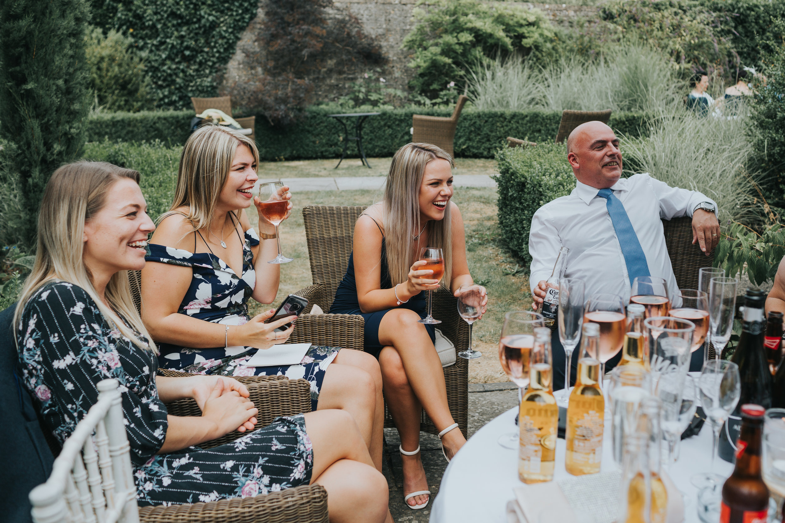 Wedding guests sitting at table laughing.  (Copy)