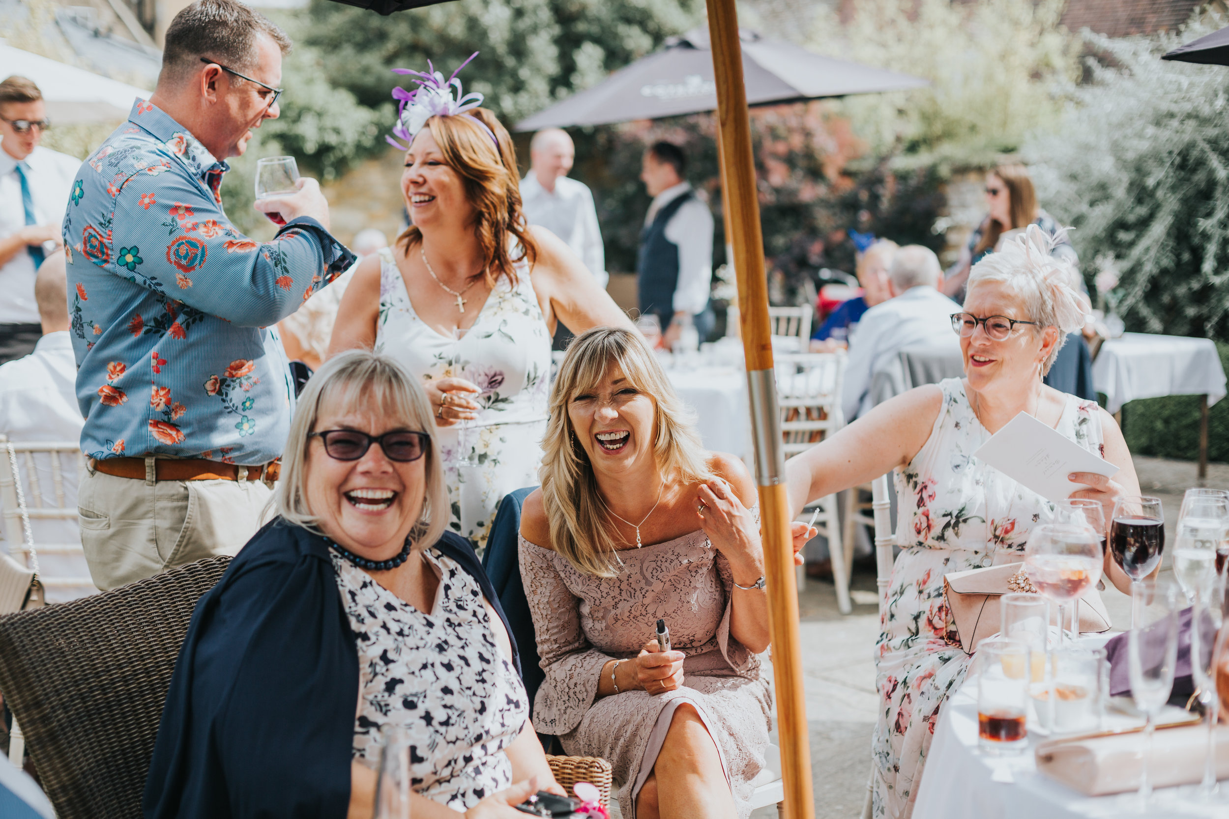 Brides mum laughs with her friends around a table.  (Copy)