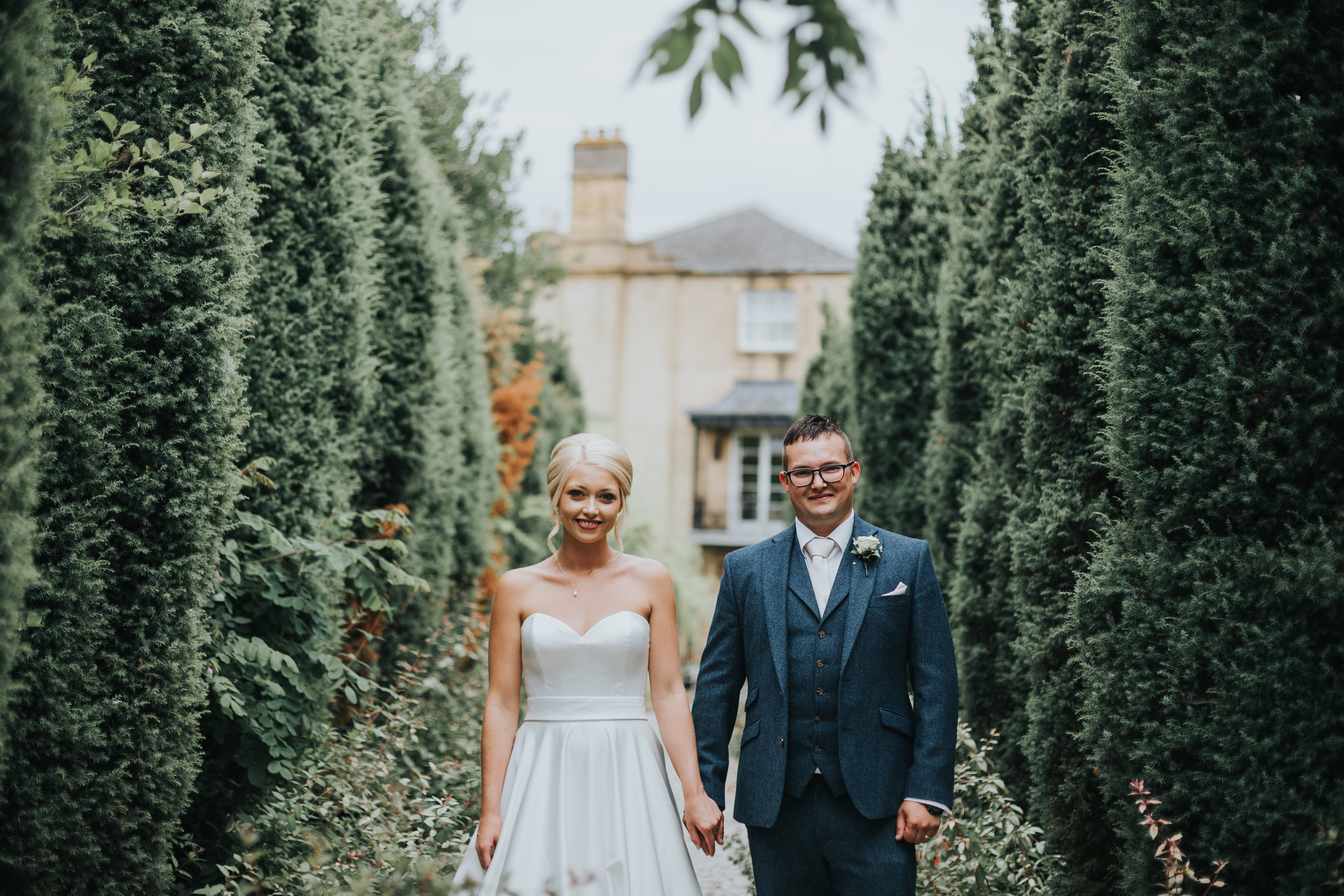 Bride and Groom Stand Side by side in Italian looking tree rowed path.  (Copy)