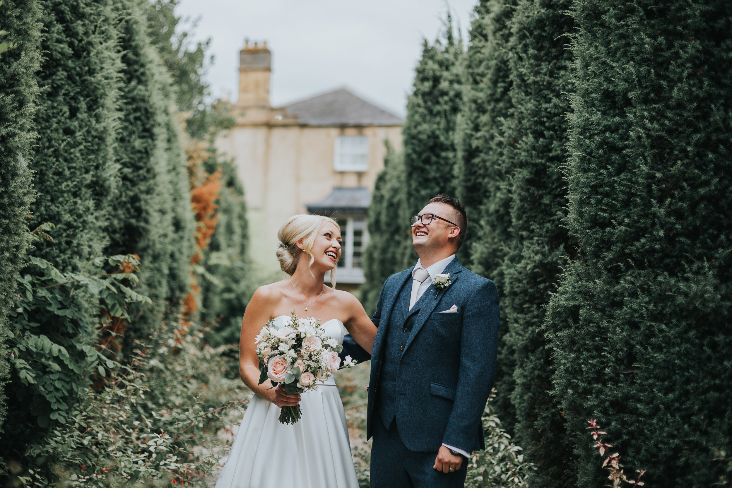 Bride and Groom Laugh together in Italian garden.