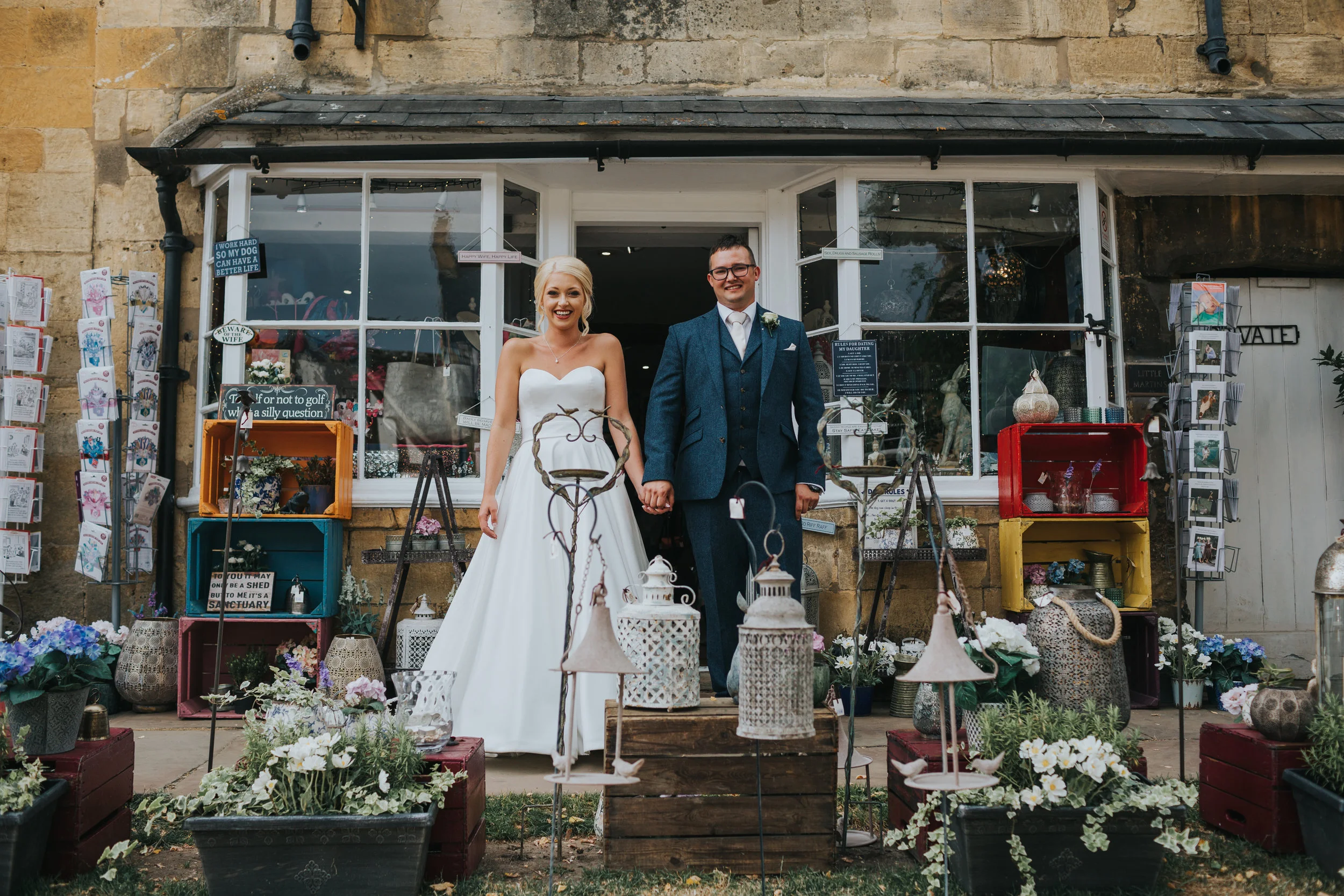 Bride and Groom two step pose outside shop. (Copy)