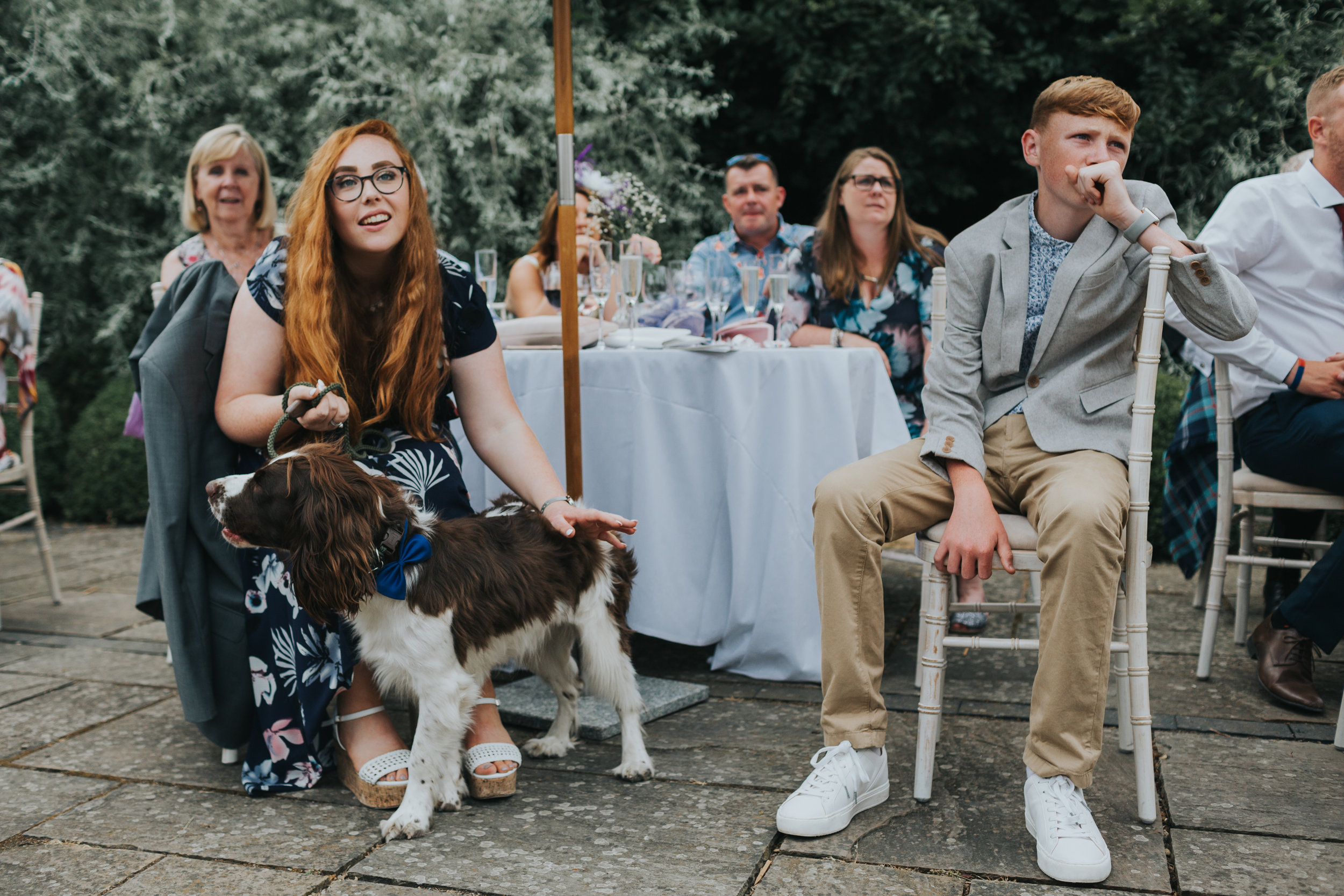 Two red haired children and a dog sit listening to the speeches.  (Copy)