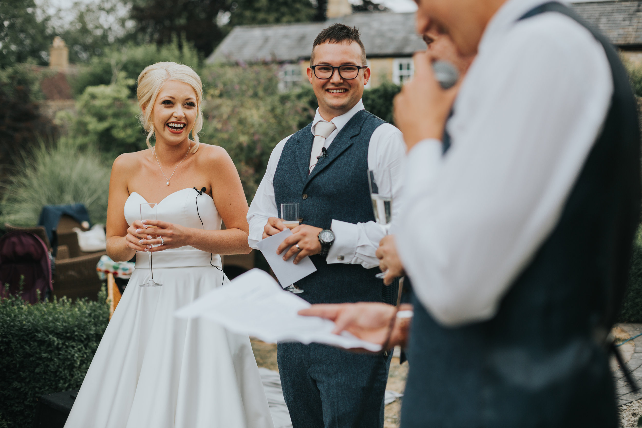 The bride laughs while the best man gives his speech.  (Copy)