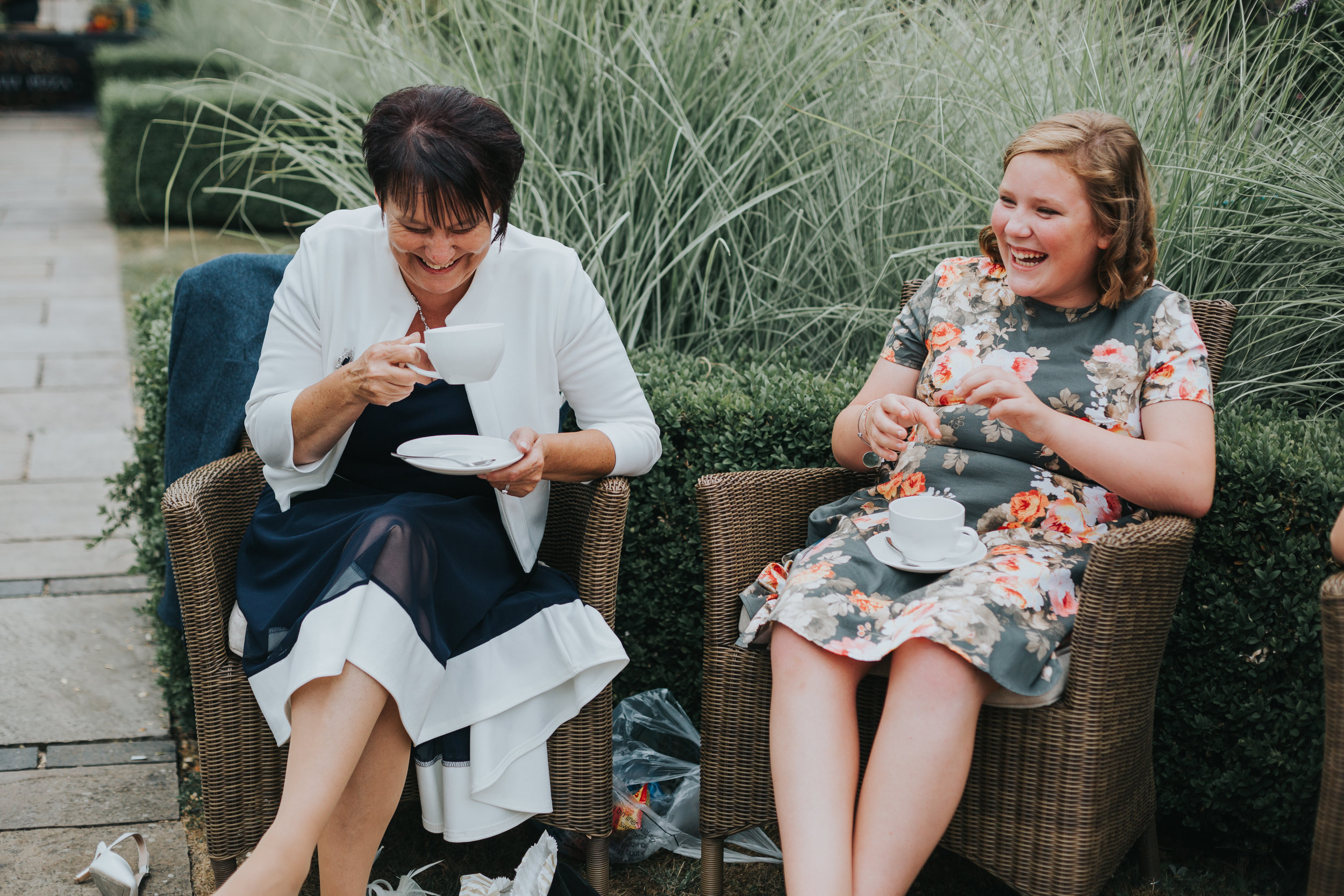 Two female guests laughing together while drinking a cup of tea.  (Copy)