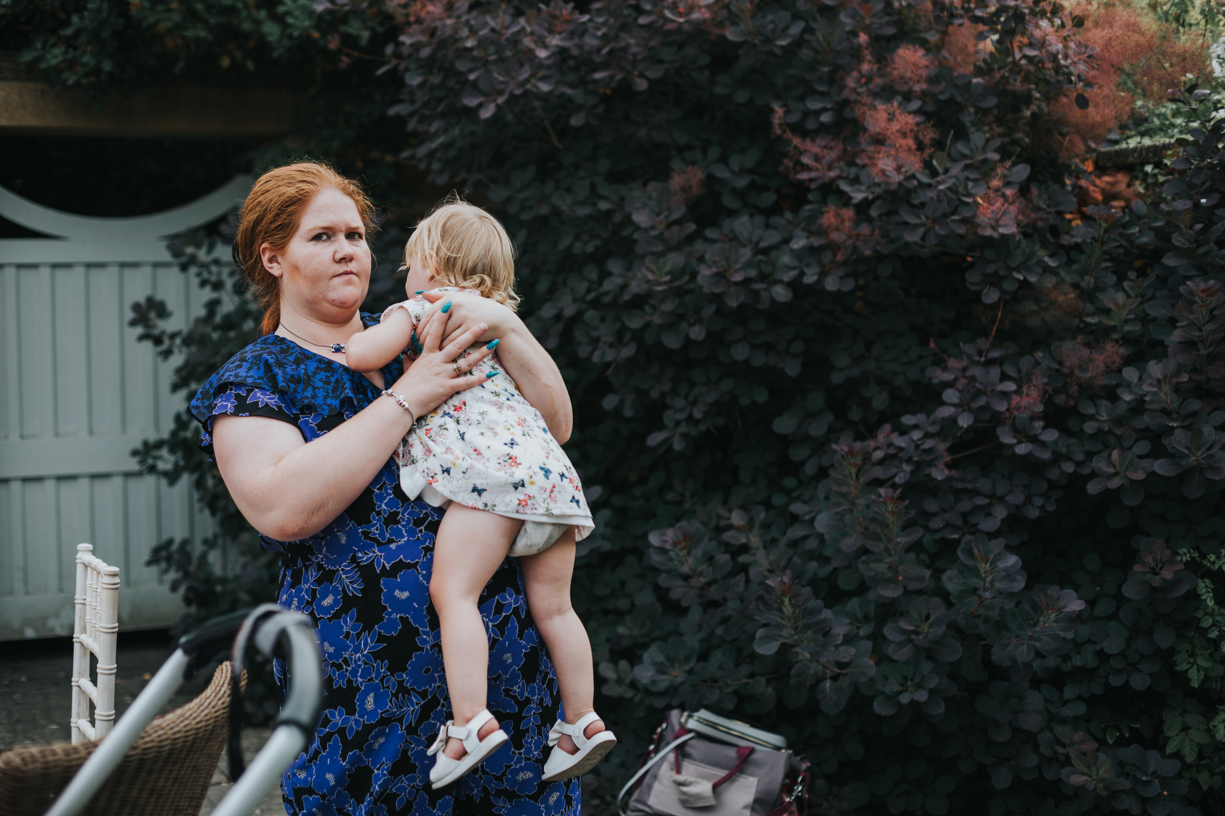 Wedding guest holding her daughter.  (Copy)