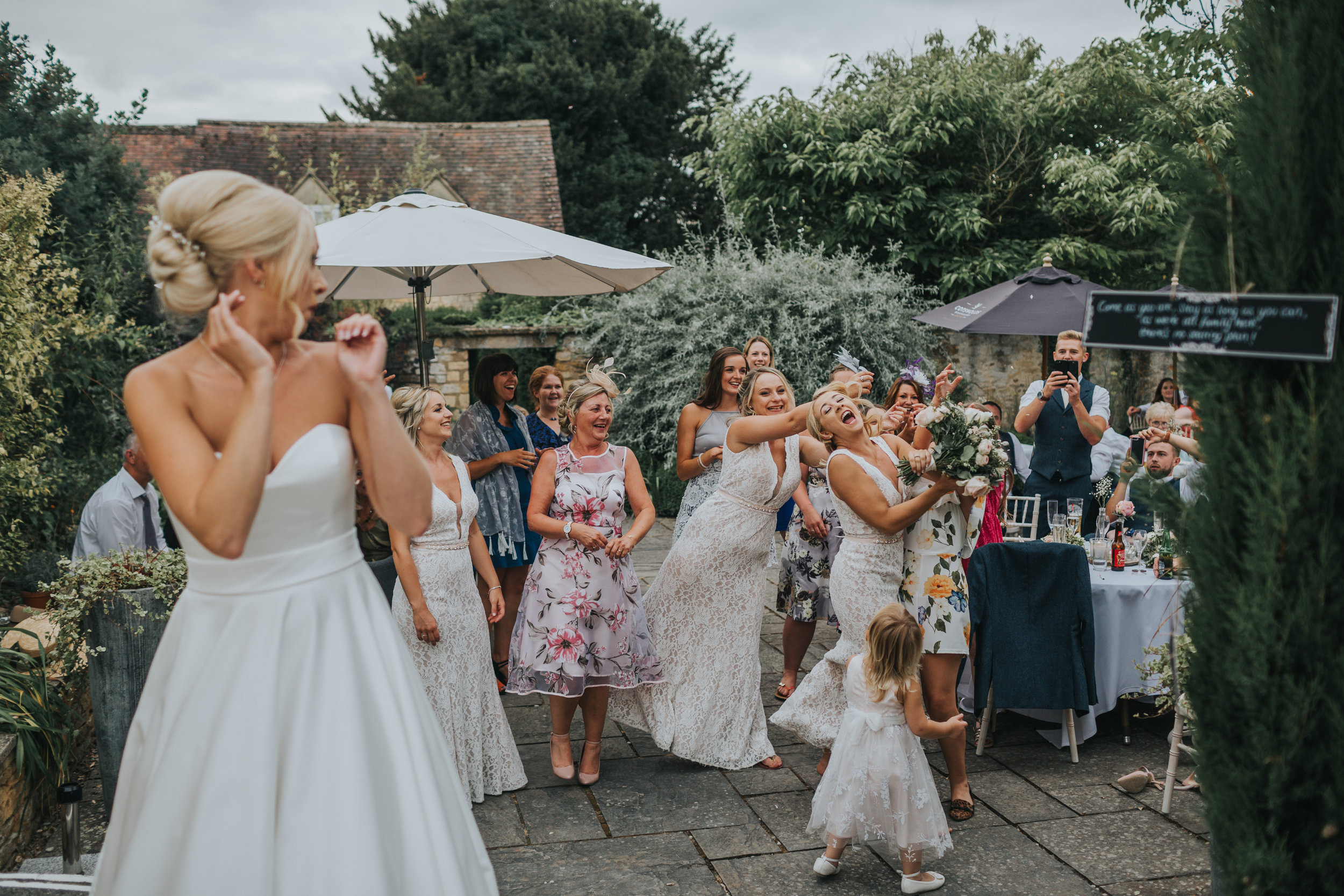 Bride throws bouquet and her sister catches it. (Copy)