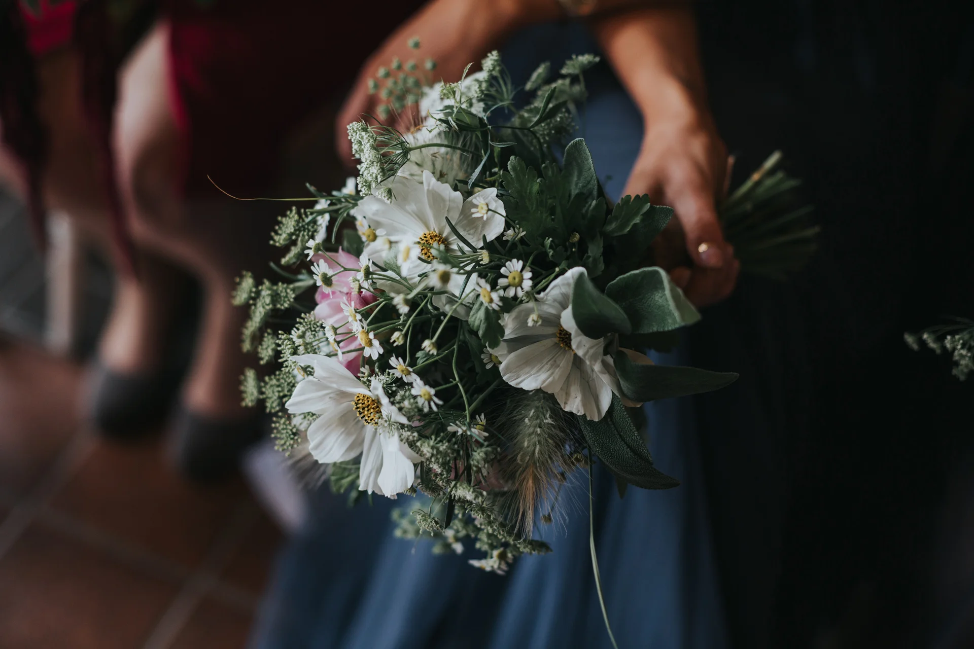 Close up of a bridesmaids bouquet of wild seasonal flowers. 