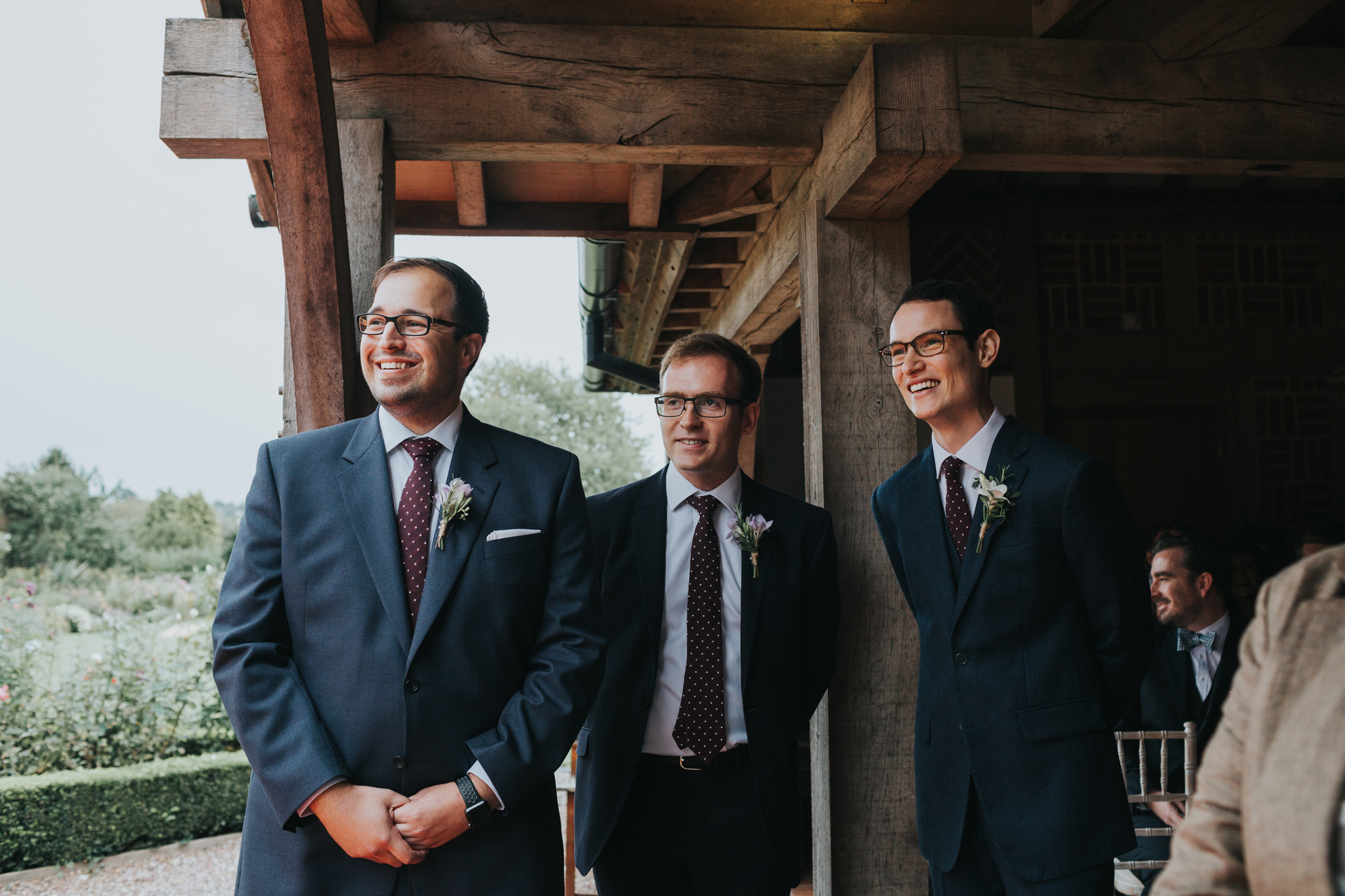 Groom and his groomsmen stand waiting for his bride to arrive. 