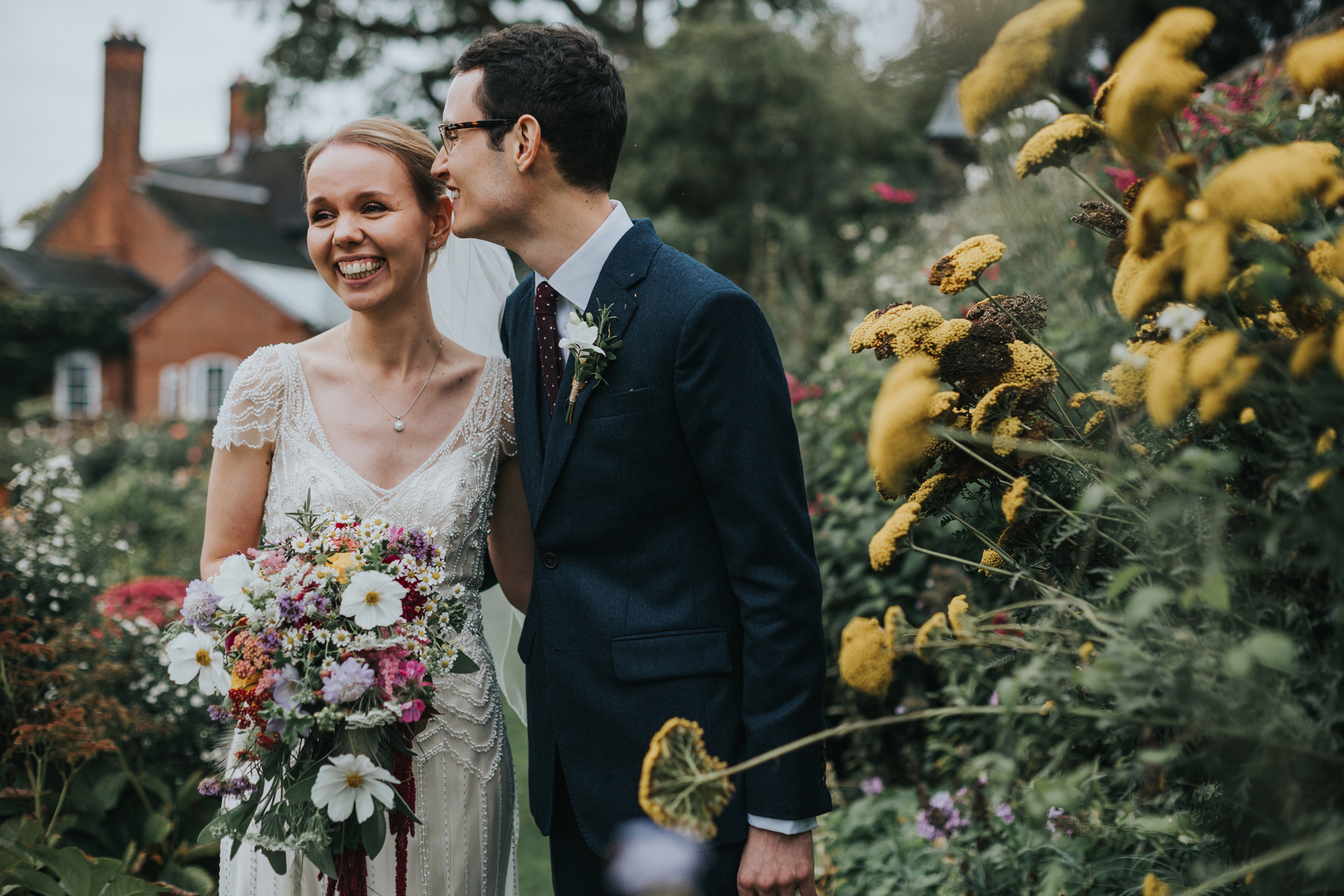 Bride and groom standing in gardens at Goldstone Hall, Market Drayton.