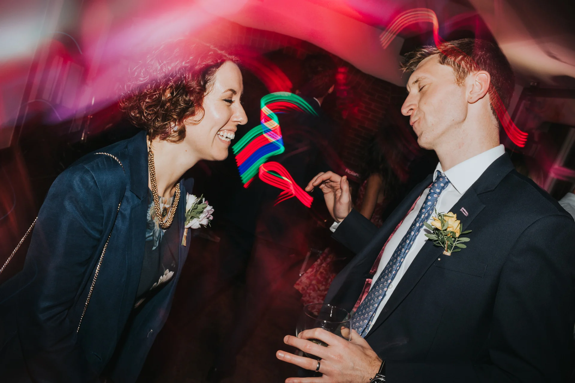 Couple laugh while dancing together. 