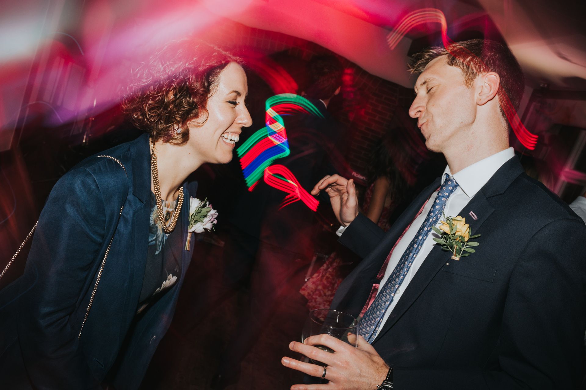 Couple laugh while dancing together.