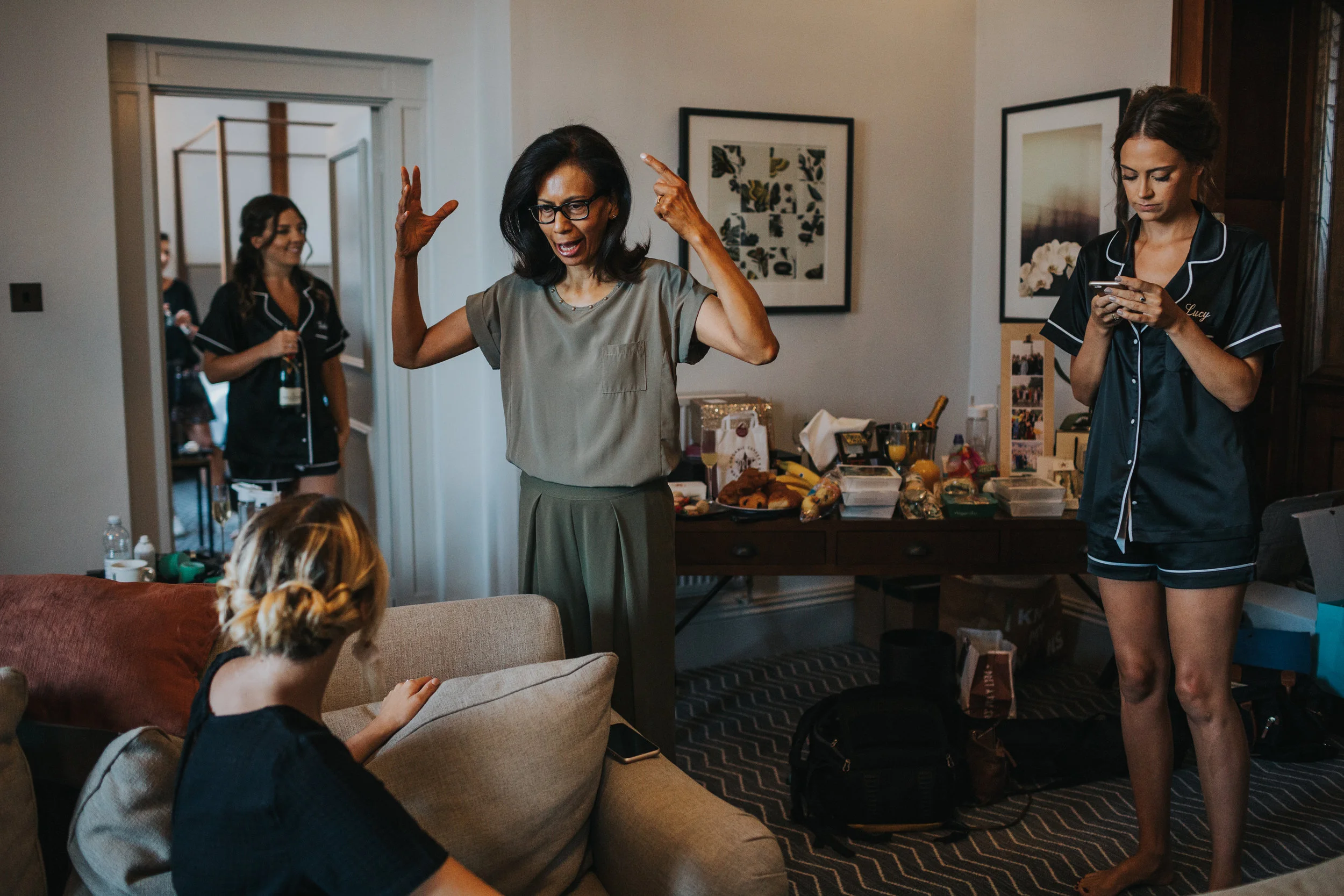 Mother of the bride is saying something big with her arms.